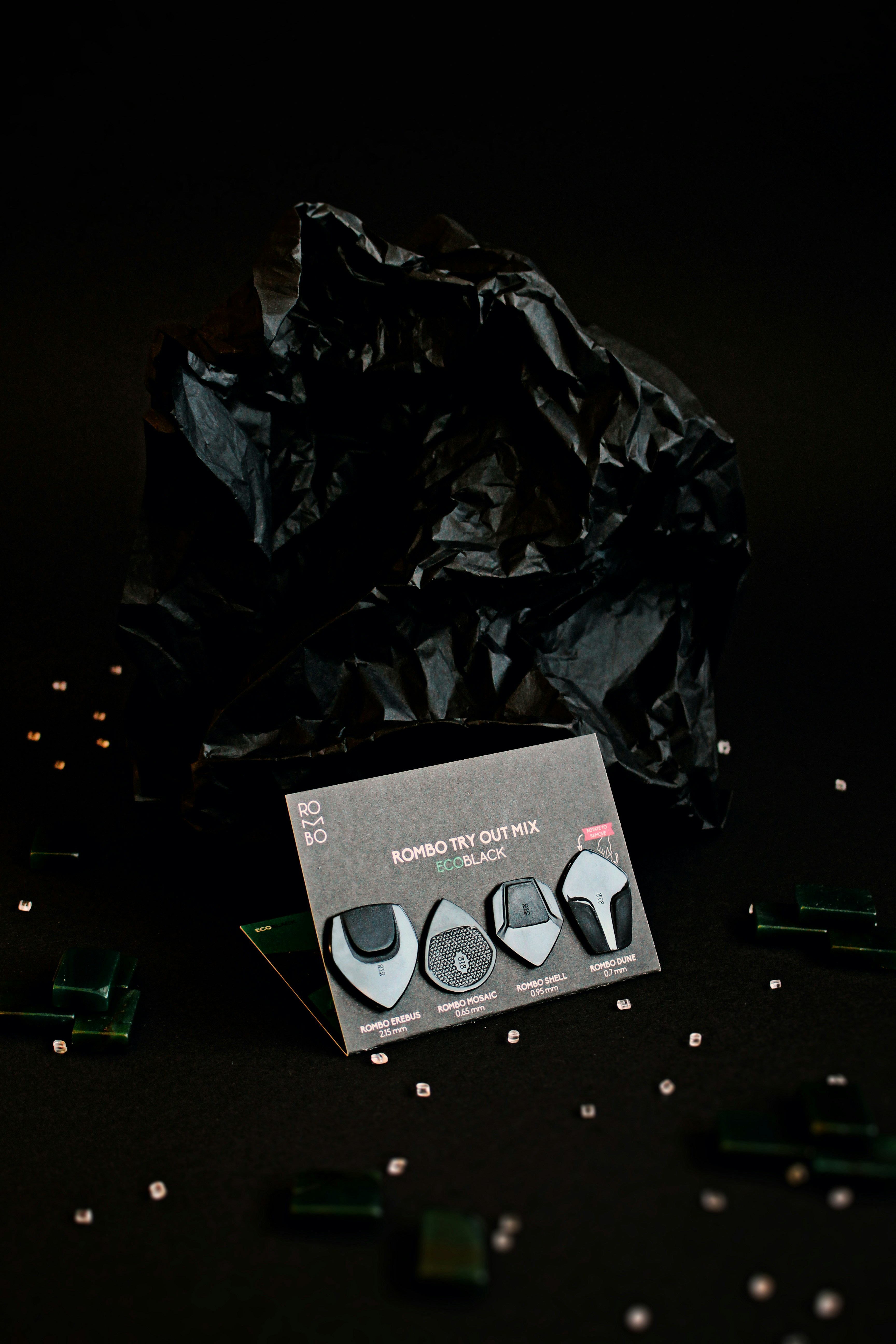 a pair of black shoes sitting on top of a black table