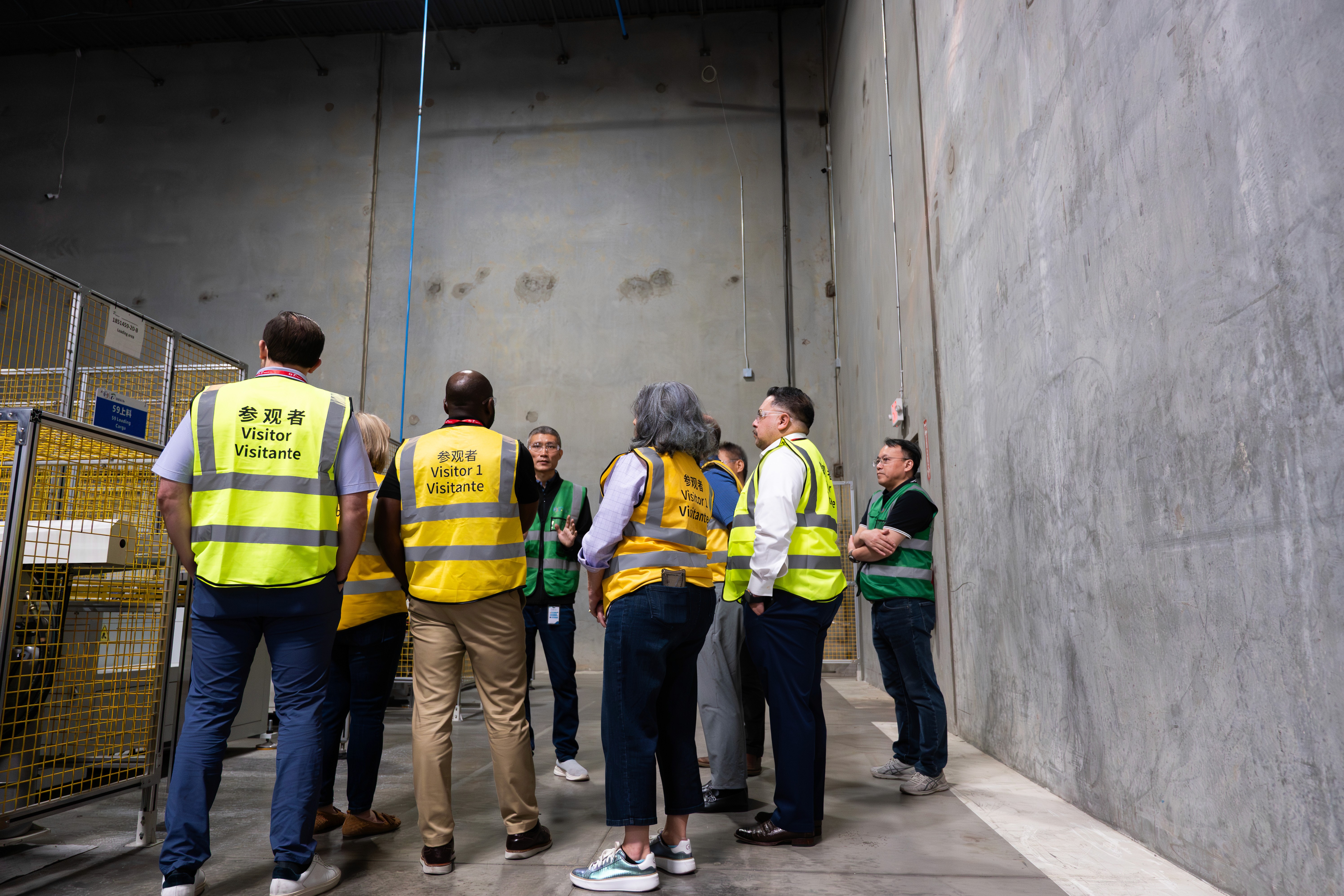 photograph of a group of city officials and employees touring a manufacturing facility in Irving, texas.