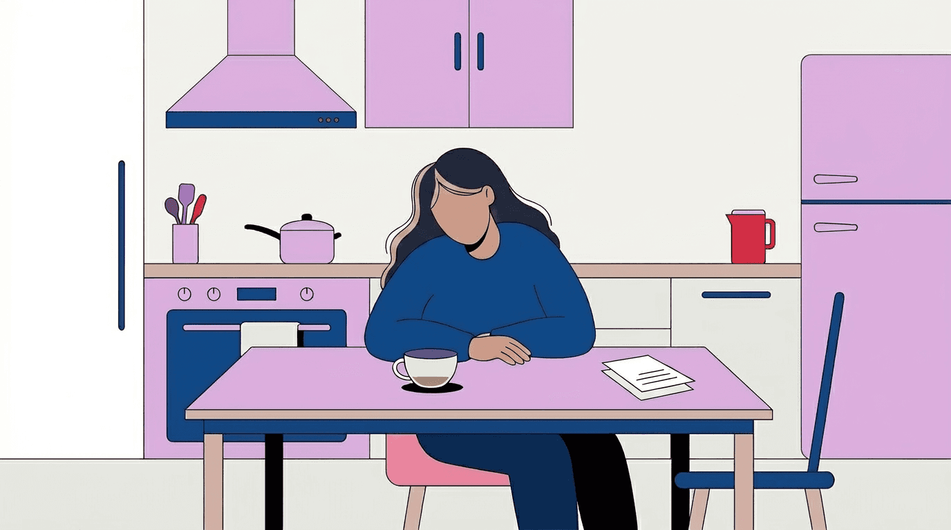 A tired caregiver rests her head on her arm at a kitchen table, a coffee cup and a single sheet of paper beside her.