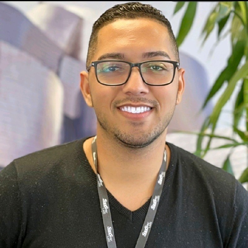 smiling woman wearing white and black pinstriped collared top