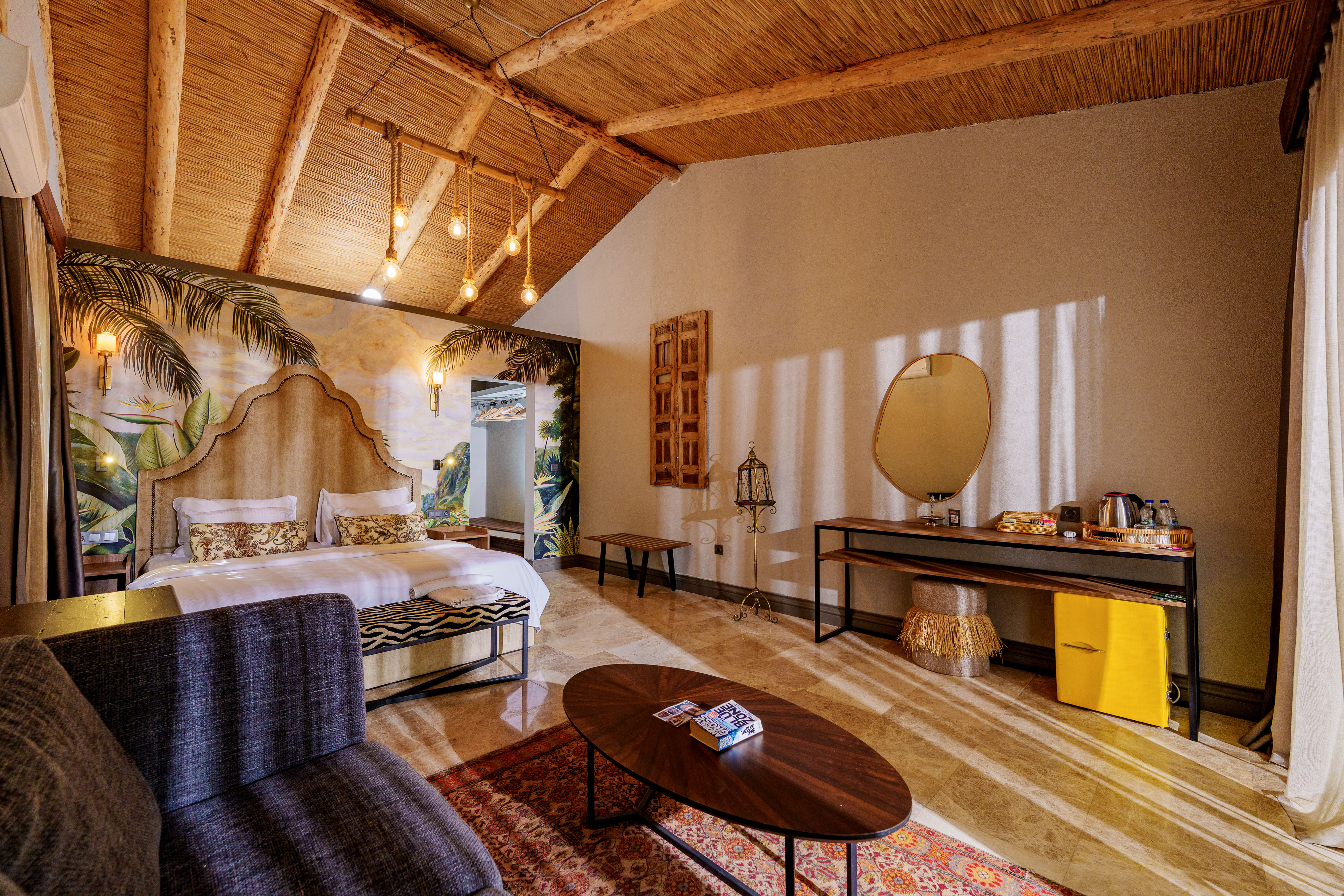Evening mood lighting, with the balcony doors open, glowing bedside lamps, sunset light streaming in.