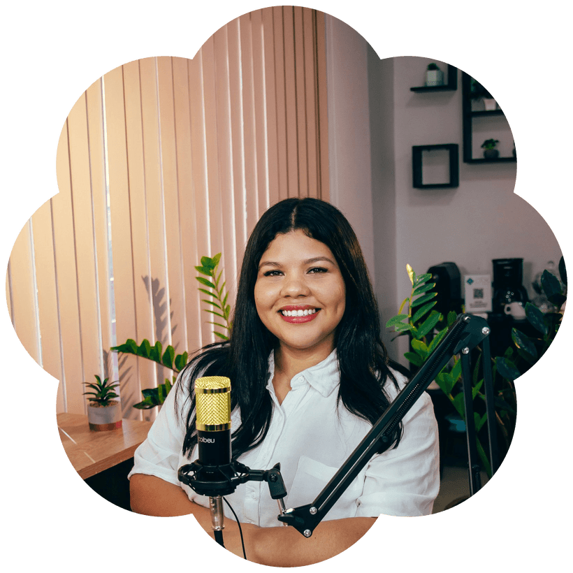 Woman recording a podcast at a desk microphone