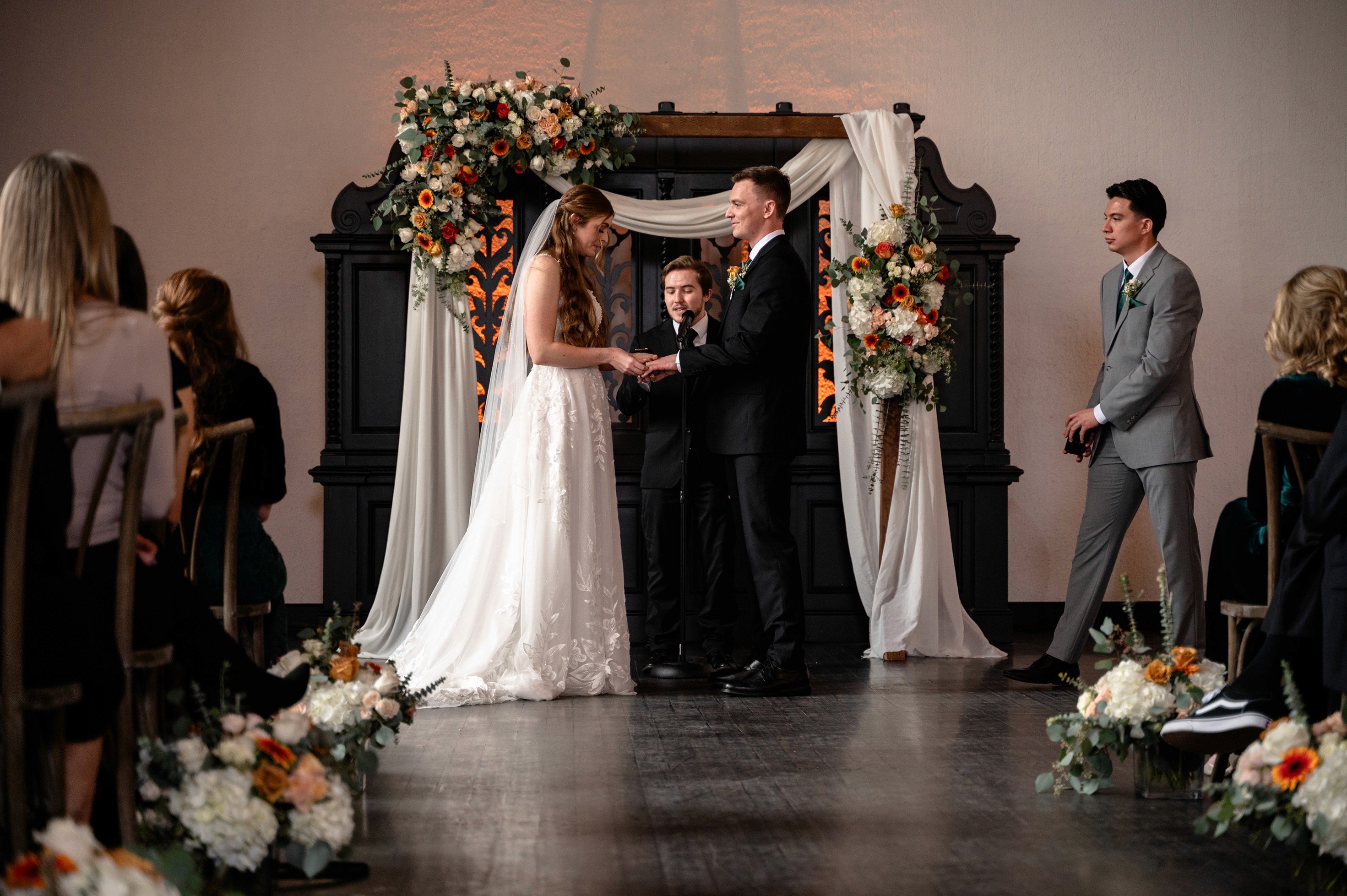 Flat lay wedding details with bouquet, rings, and sparkling bridal heels