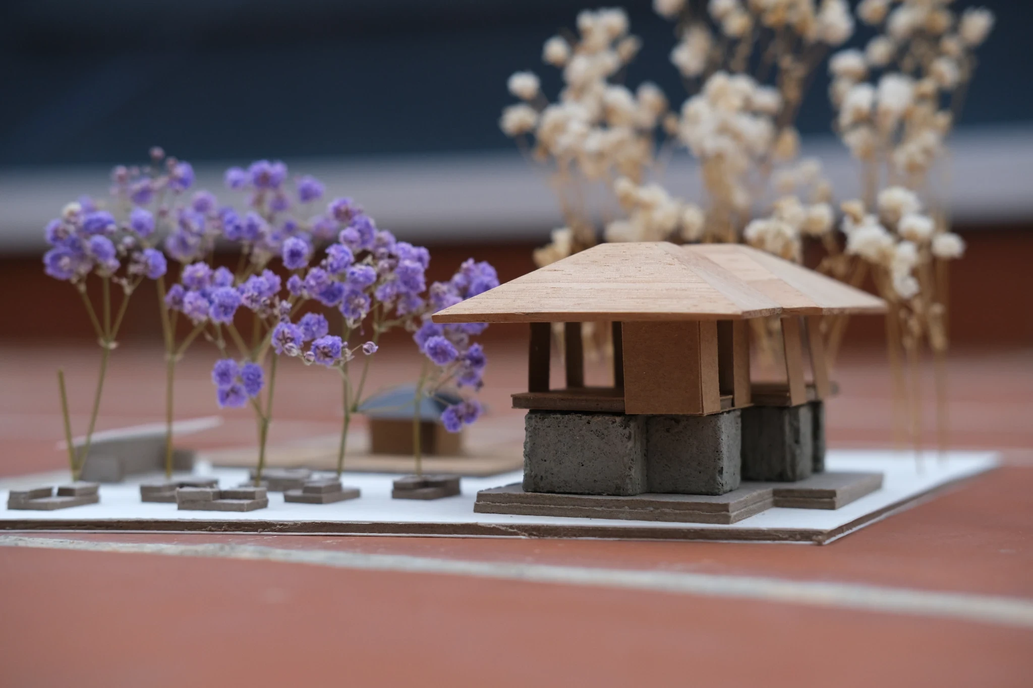 Architectural detail of a community market, depicted as a 3D model showcasing the intricate roof design and traditional building materials.