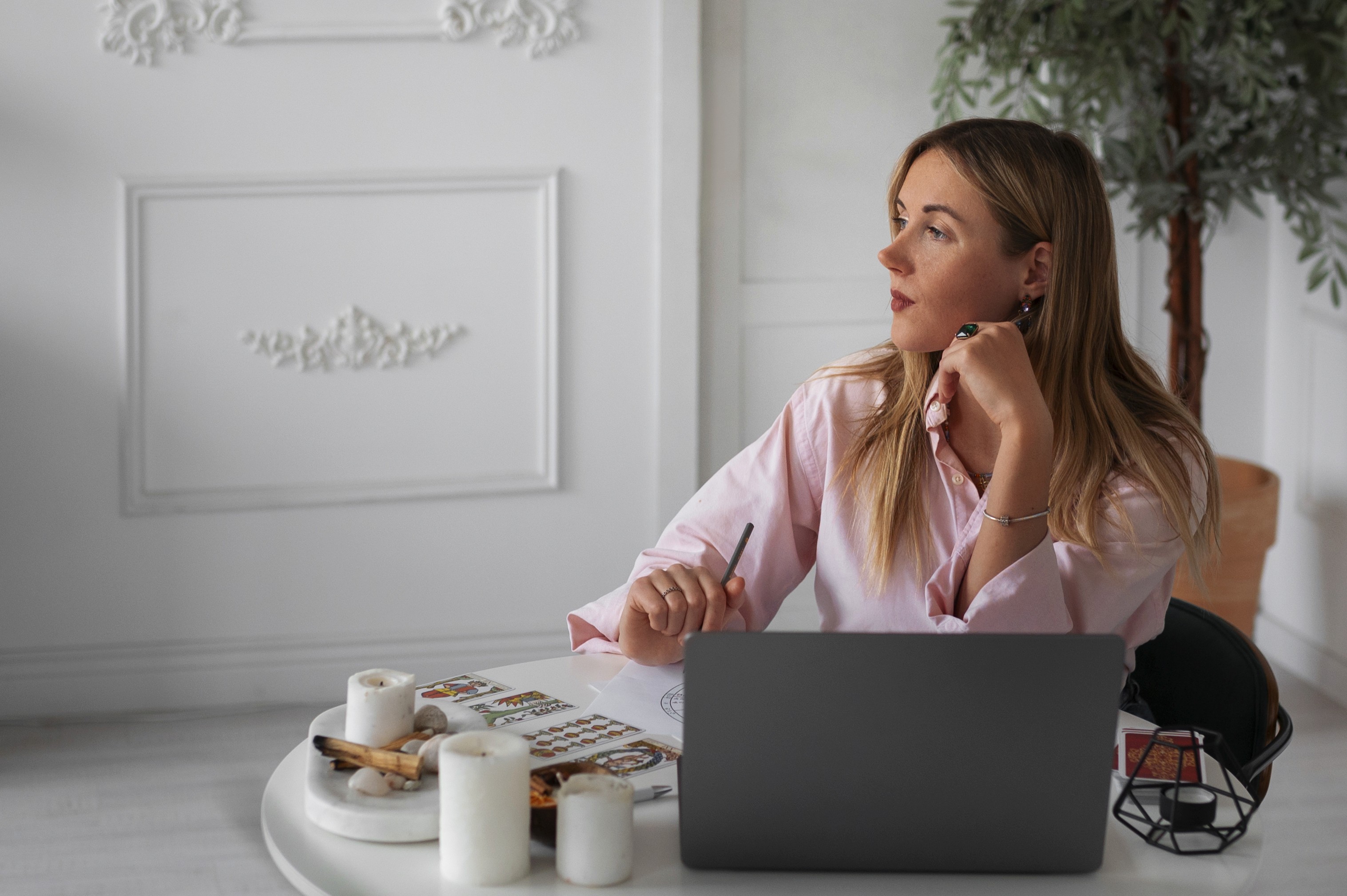Photo of beauty clinic owner sat with her laptop at a desk