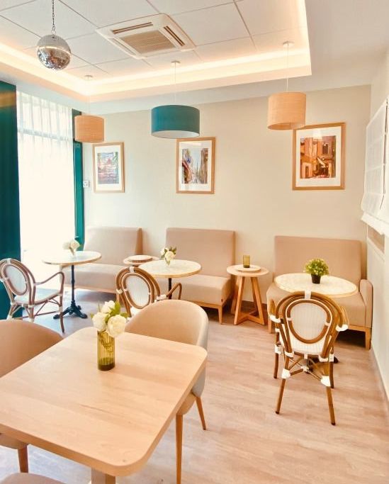 Cozy sitting room with modern armchairs	round coffee table	and contemporary wall art