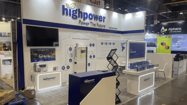 IpstisEdge RE+ Southeast 2023 energy storage booth with screen demo wall, battery system display, blue branded graphics, and technical buyer explanation area