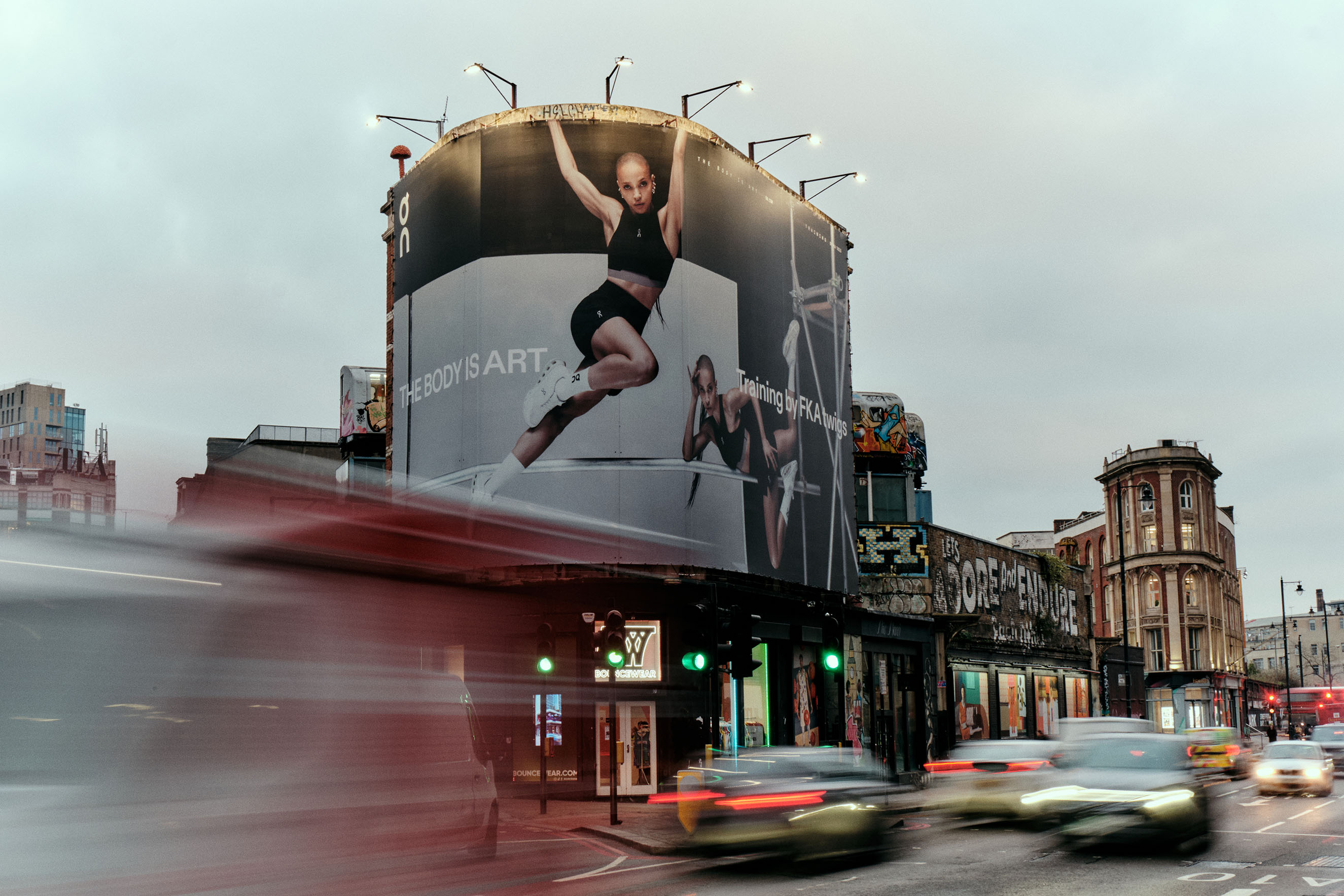 Large-scale circular outdoor billboard campaign featuring high-impact visuals of FKA twigs for the On global branding strategy, seamlessly integrated into a high-traffic urban street environment to showcase the creative studio's graphic design work.