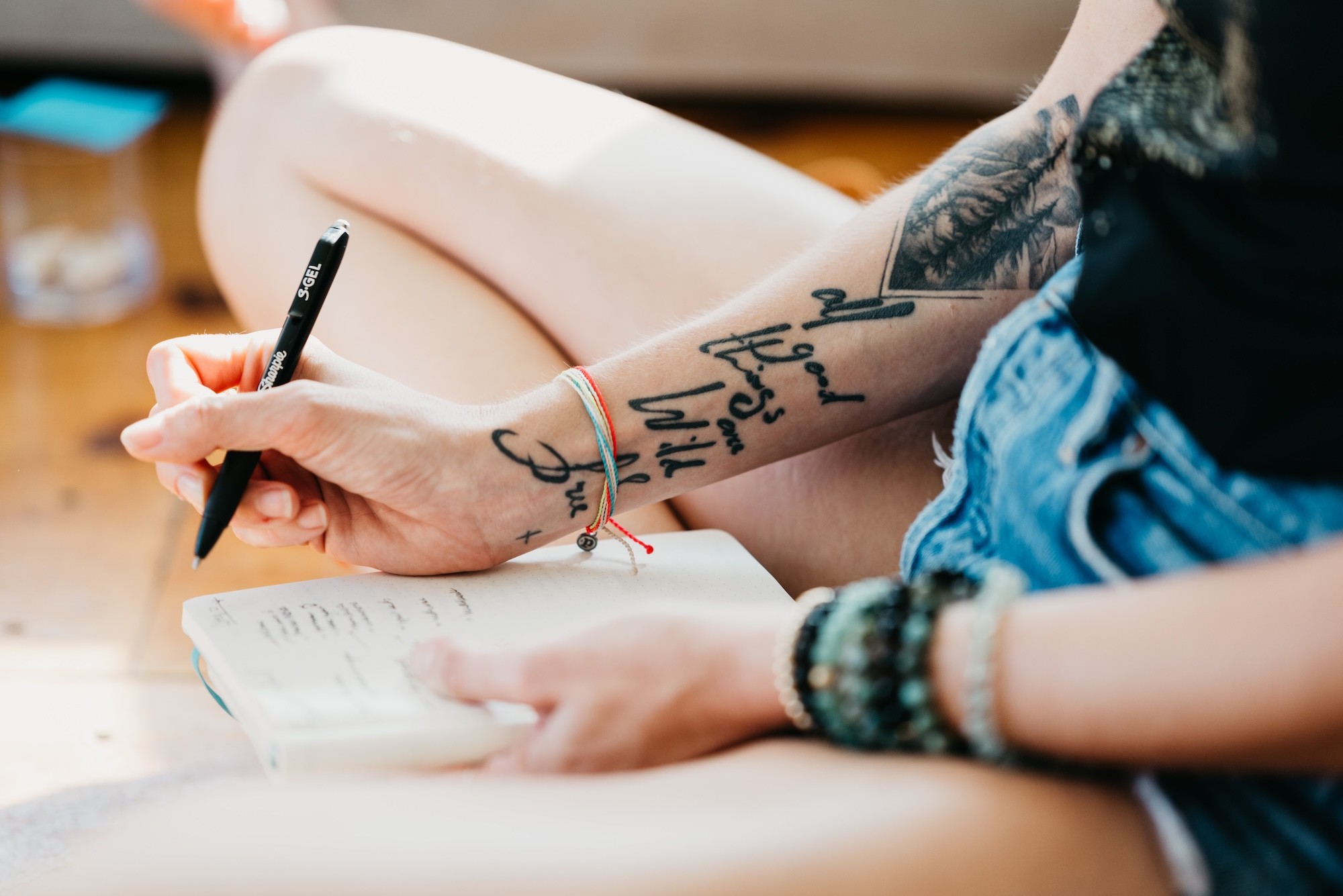 Three people sitting on a couch in a room looking at mobile devices