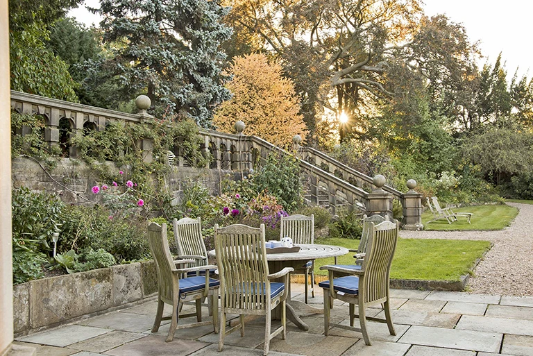 Hartingtons Heritage Tours hotel, Darley House, garden with wooden chairs and table