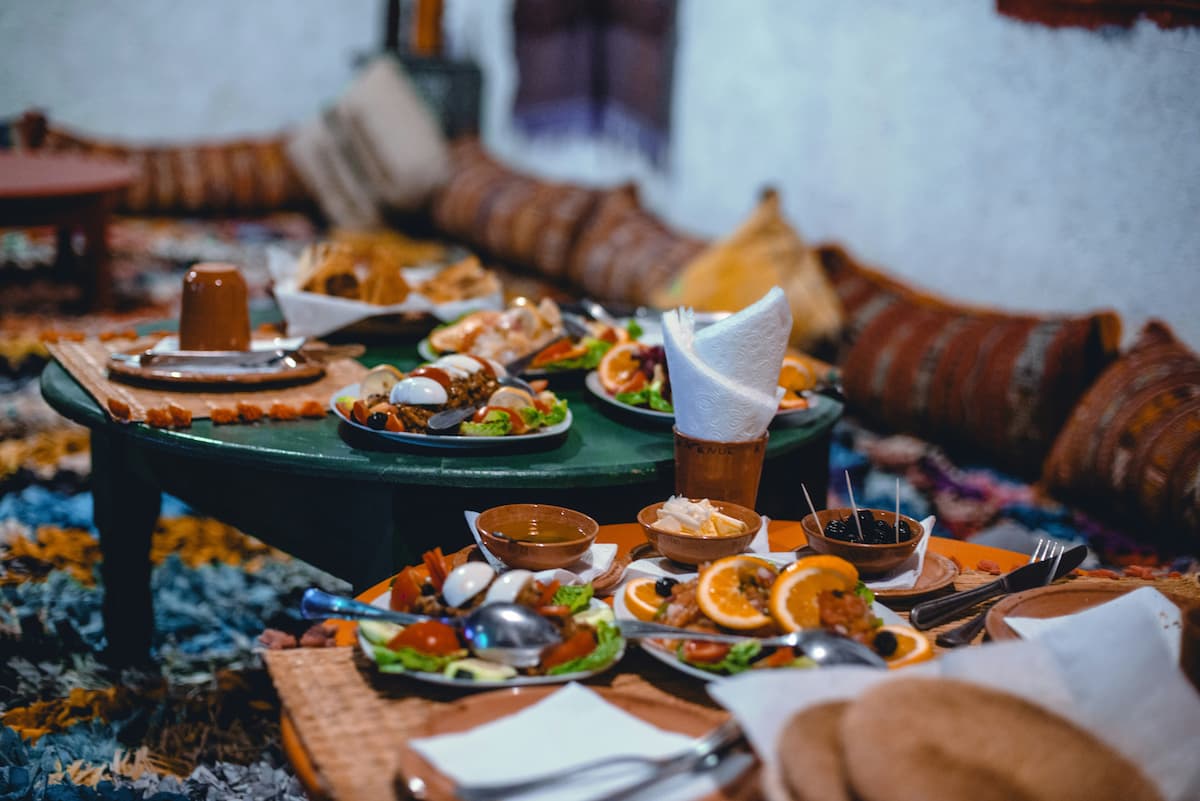 Plates of food set on diffent tables across the room