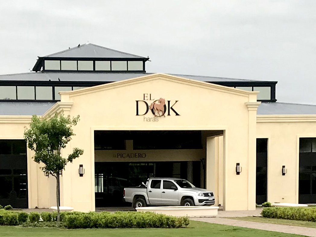 Rustic cabin in a golden field at sunset