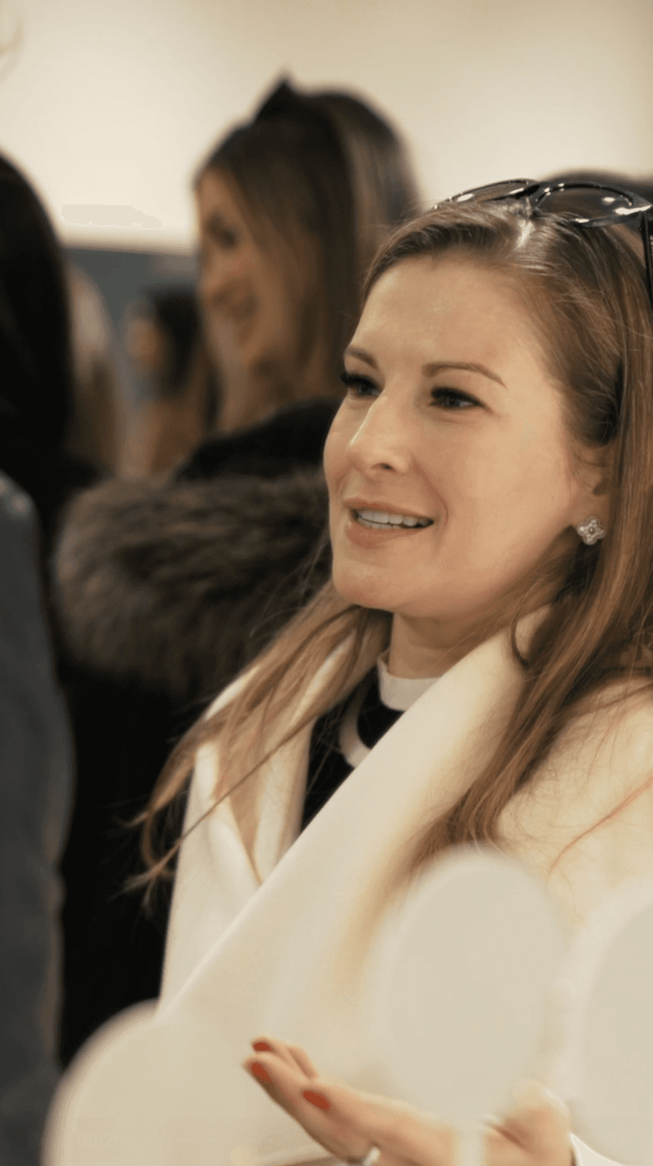 Bride sitting on ground against wall, groom standing nearby