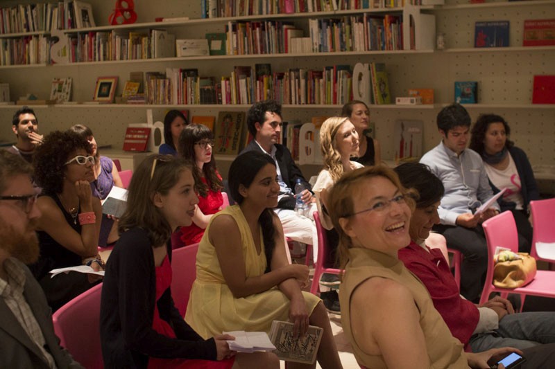 people in red chairs listening