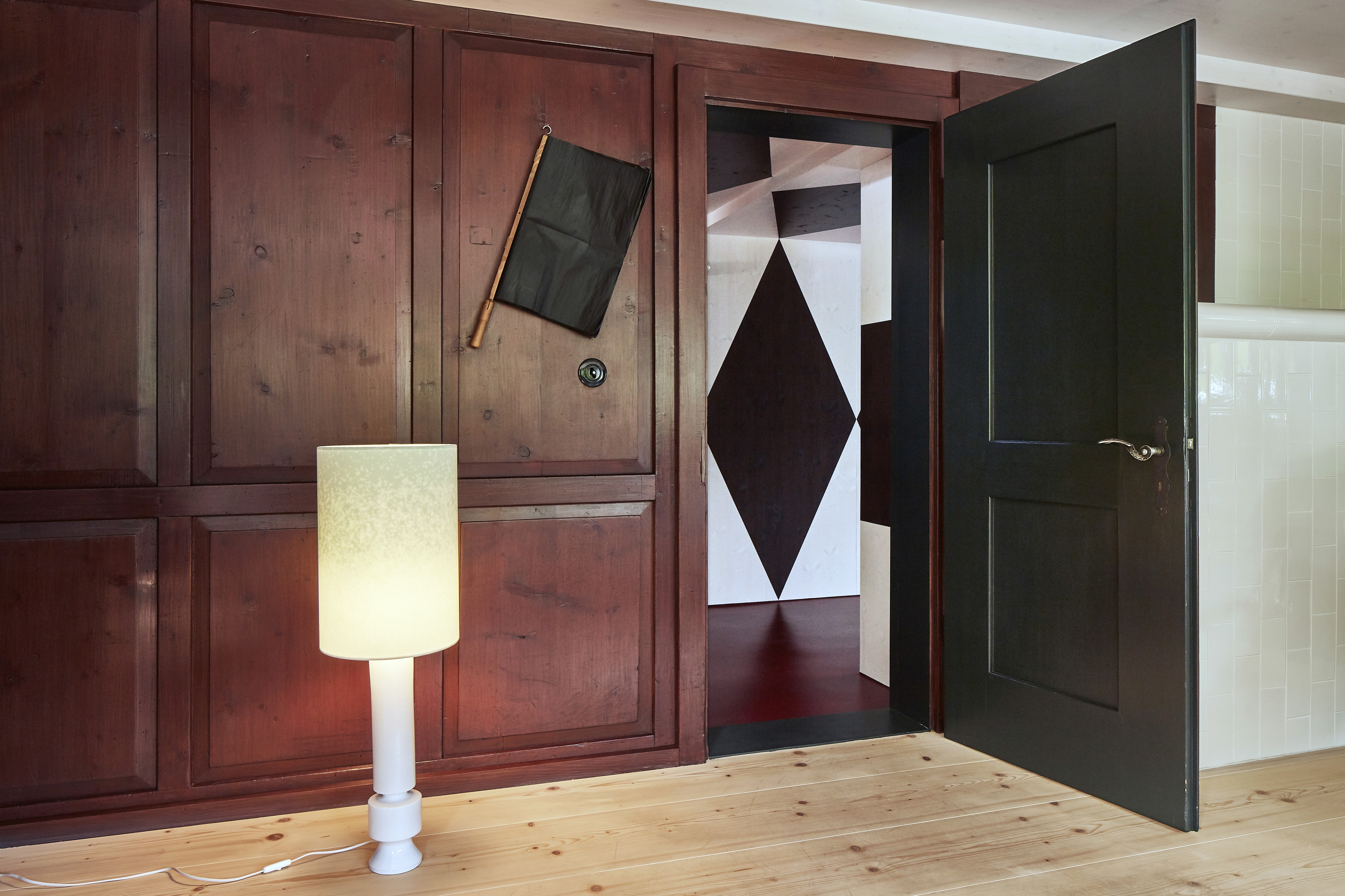 Living room of Aux Losanges showing red painted wooden panels.