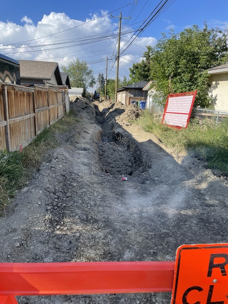 a large building with a lit up sign in front of a city skyline