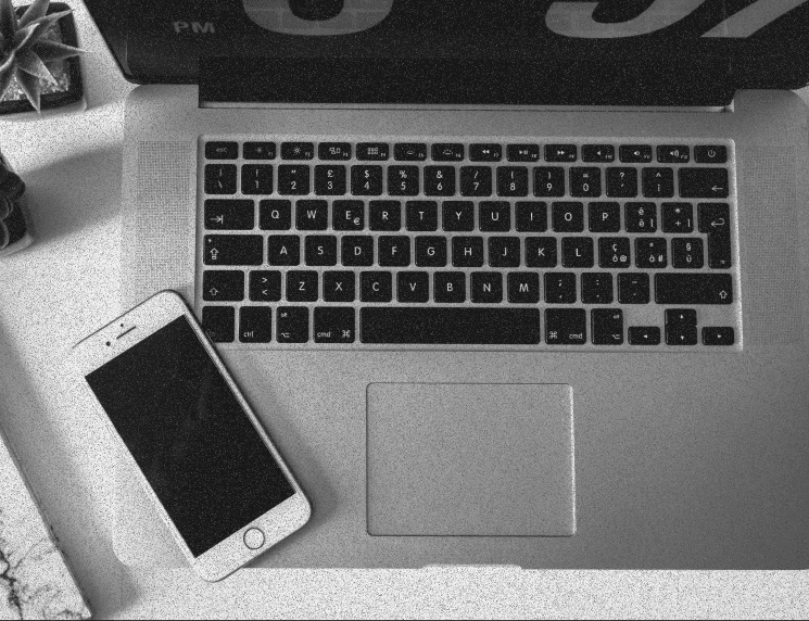A laptop and iphone on a desk