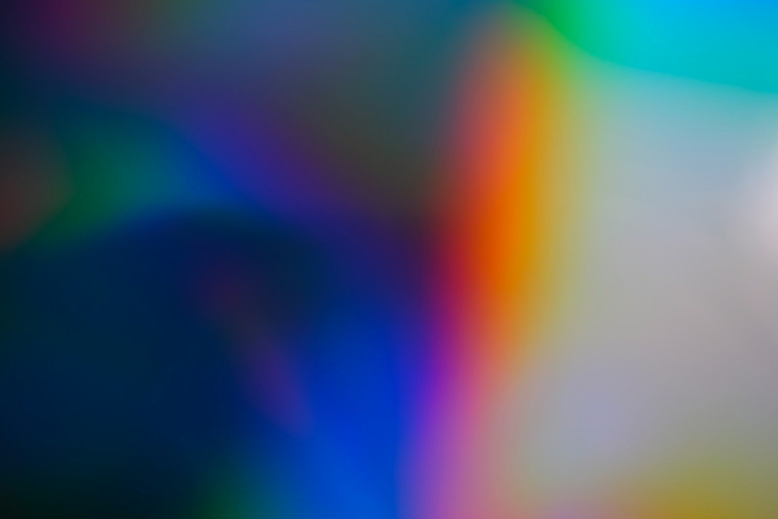 Figure lit by colorful projected light, representing focused, well-managed creative collaboration