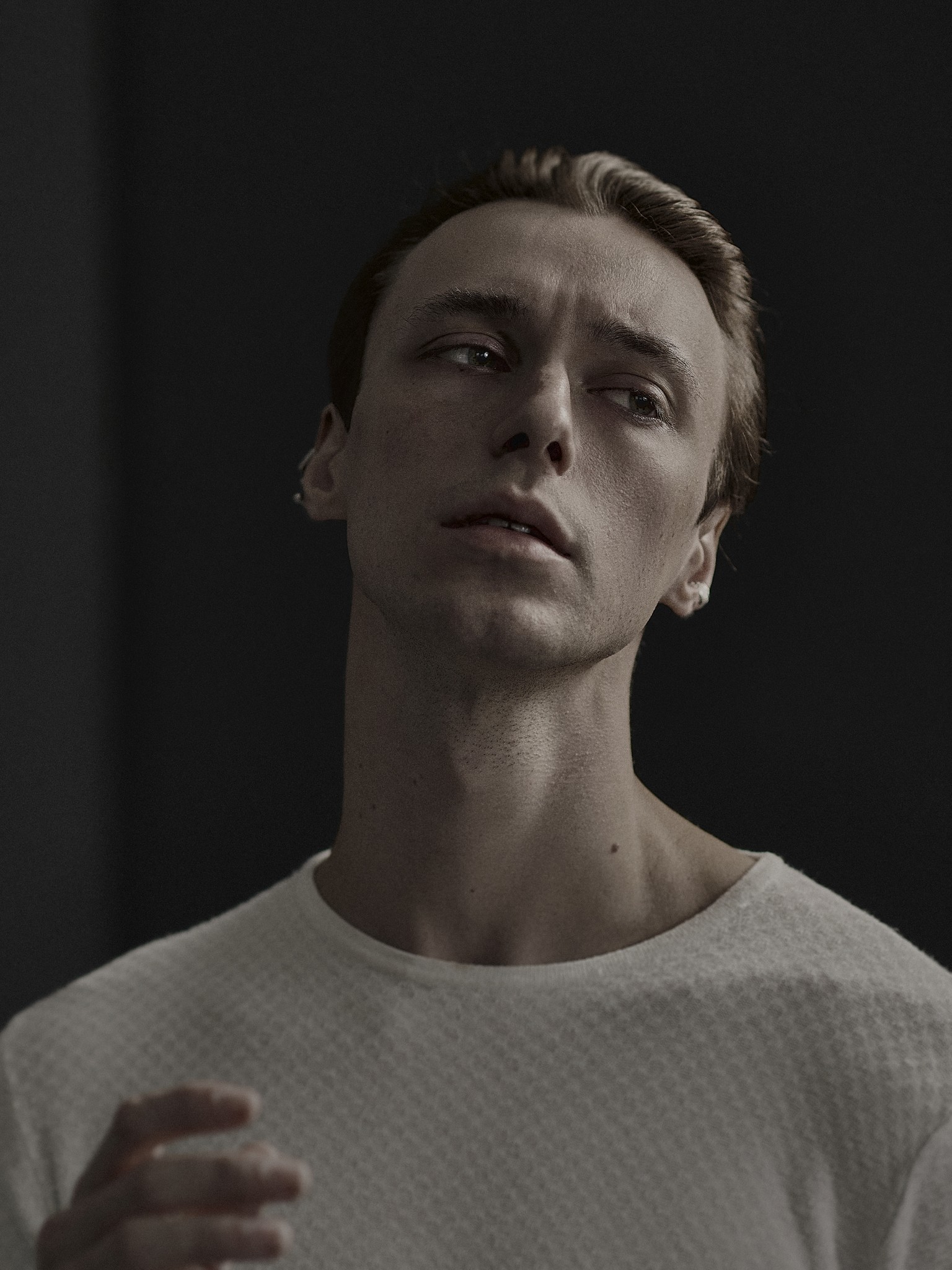 A moody and expressive photographic portrait of a young man. 