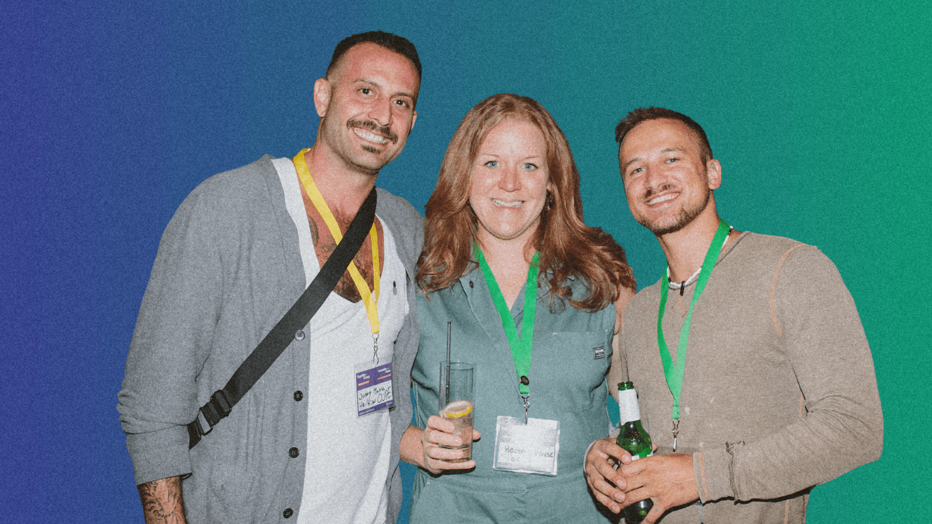 Three smiling individuals stand together against a gradient background, wearing name tags and colorful lanyards.