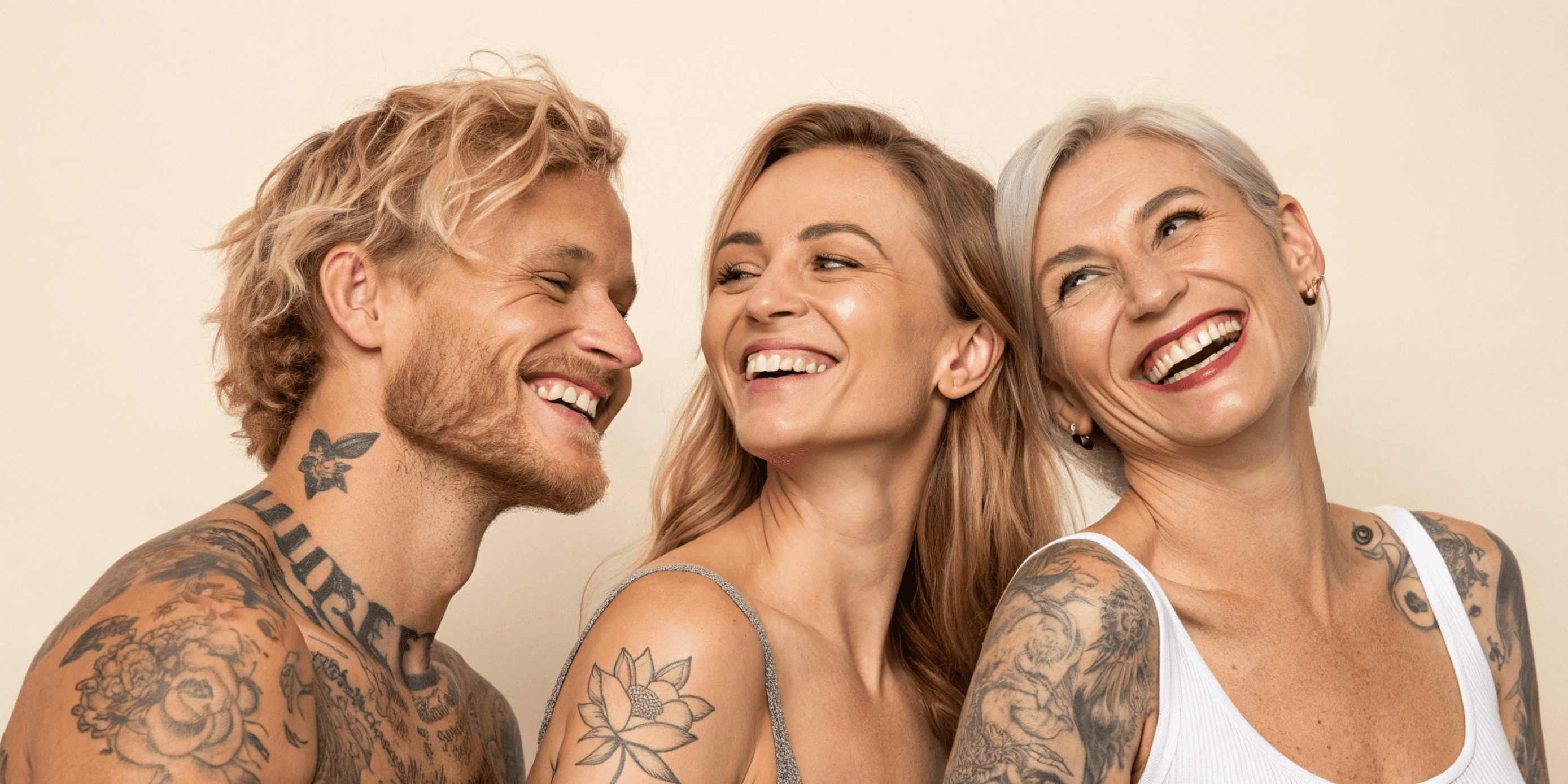 Two tattooed women smiling, inkOUT Austin natural tattoo removal