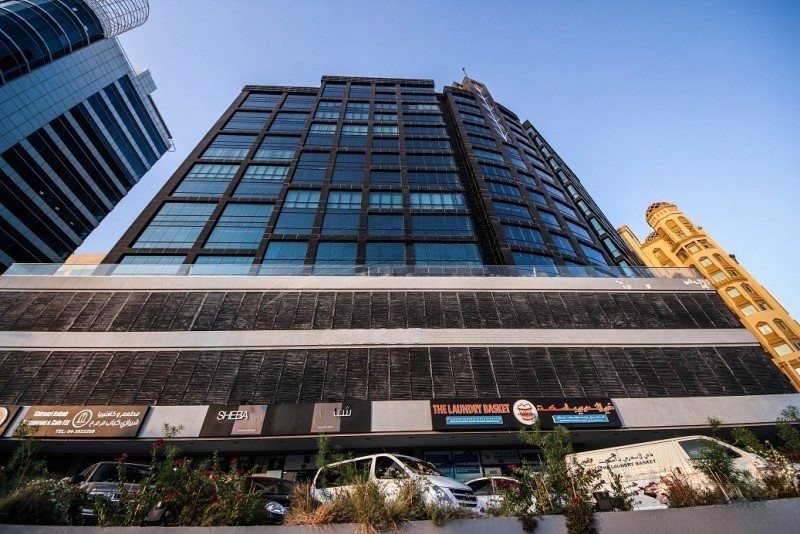 Exterior view of the building at a busy intersection, emphasizing excellent connectivity and accessibility.