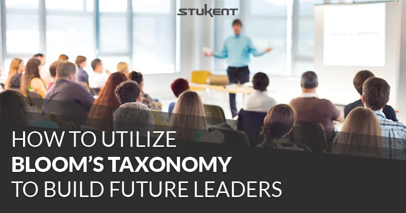 Instructor speaks to a classroom of students seated in rows. Text reads: “How to Utilize Bloom’s Taxonomy to Build Future Leaders.” The Stukent logo appears at the top.