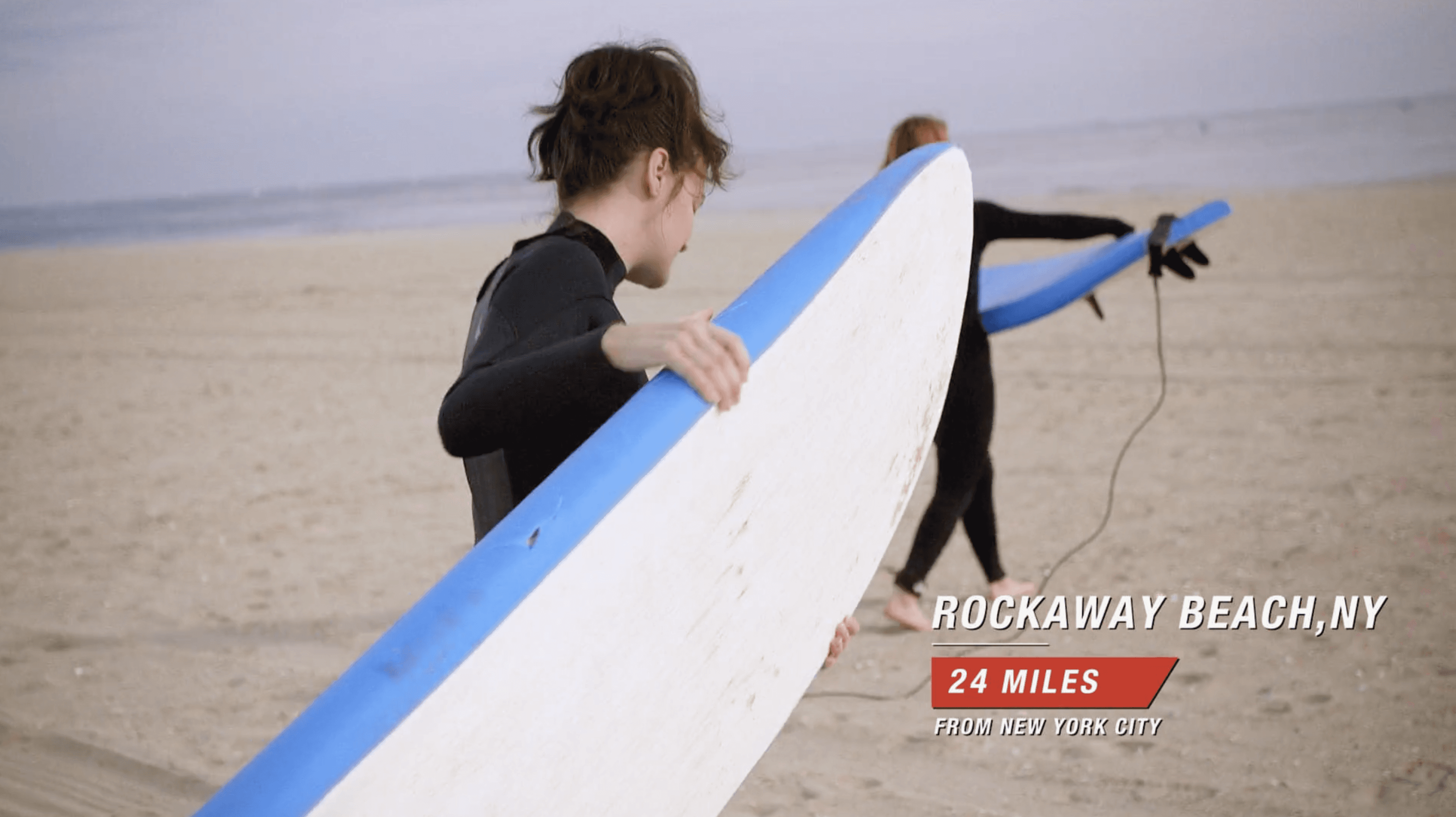 Modern home office setup with a monitor, ergonomic chair, keyboard, and indoor plants near a window with blinds.