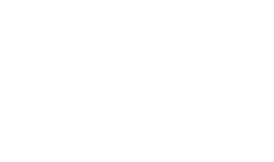A Rubik's Cube with distinct, colorful sides stands on a white surface, showcasing a partially solved pattern.