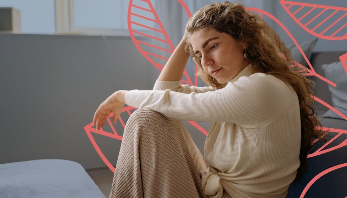 Young woman sitting on the floor looking somber