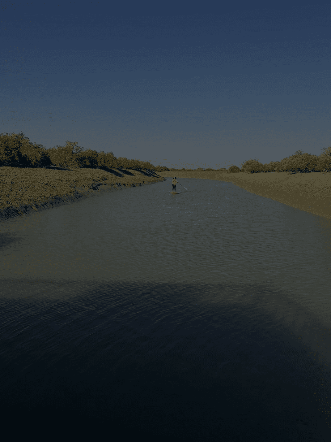 Skyscrapers shrouded in fog at night, with illuminated windows and red lights.
