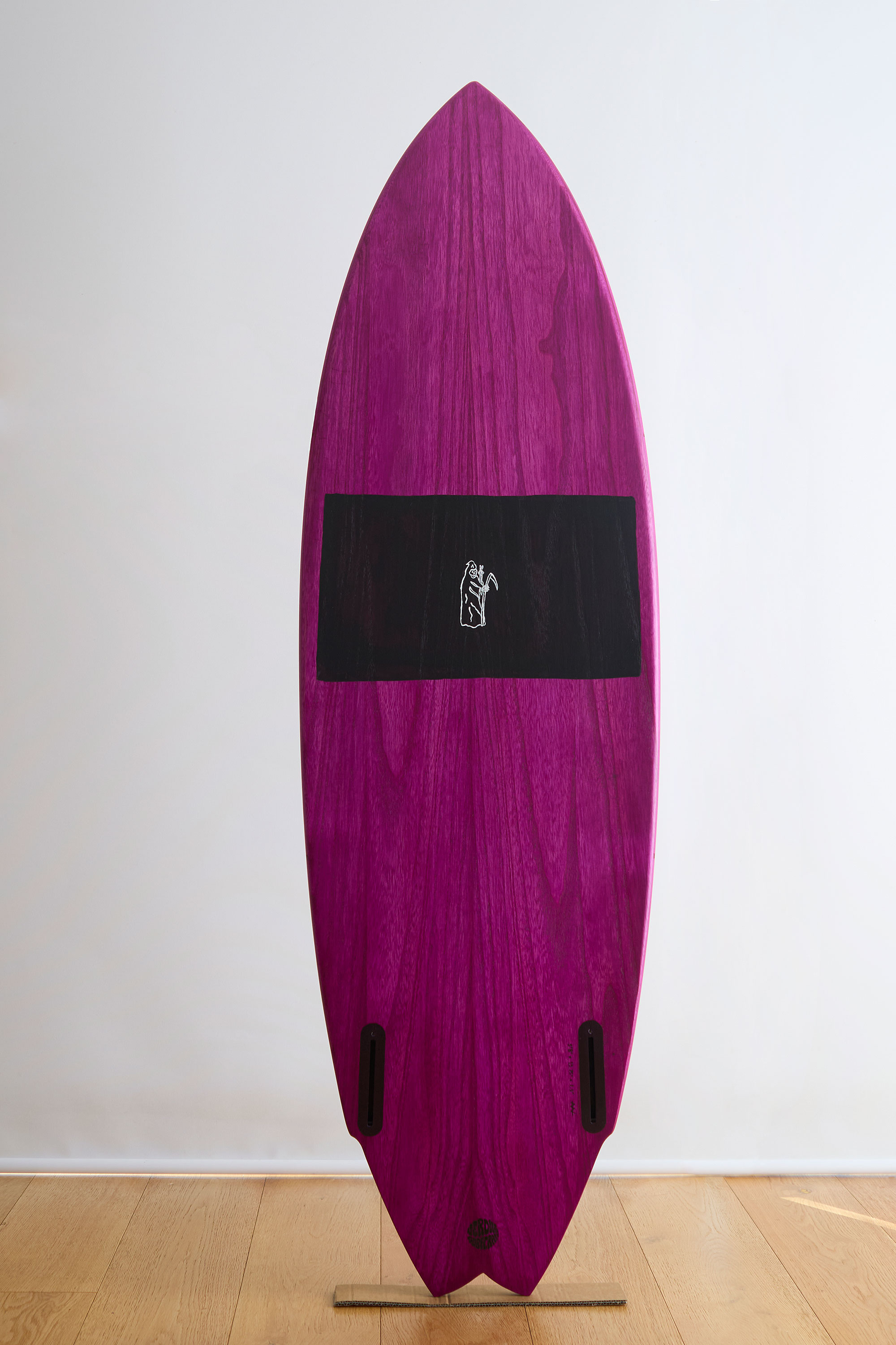 Purple and black splatter painted wooden surfboard