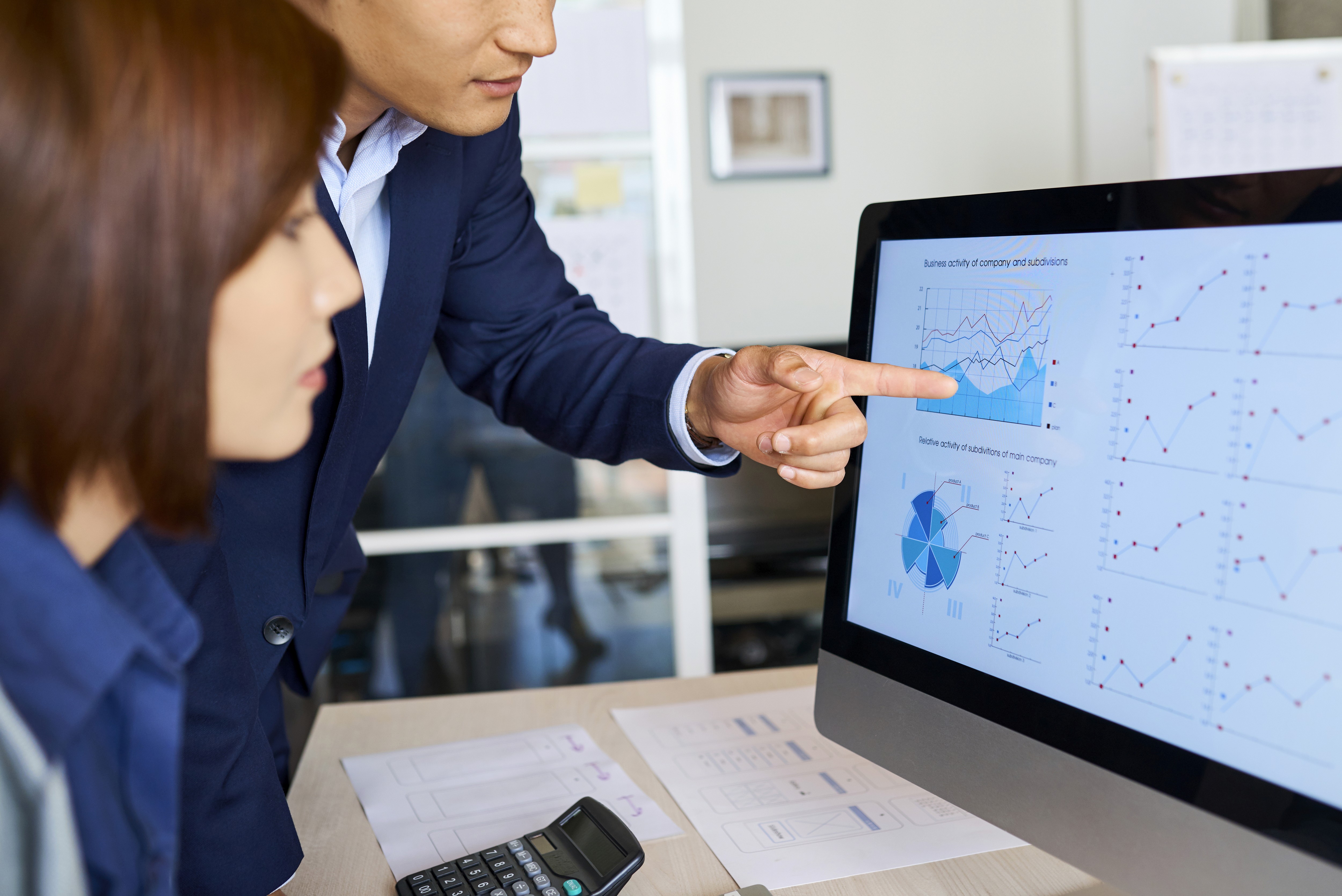 business people looking at a graph showing growth with SEO
