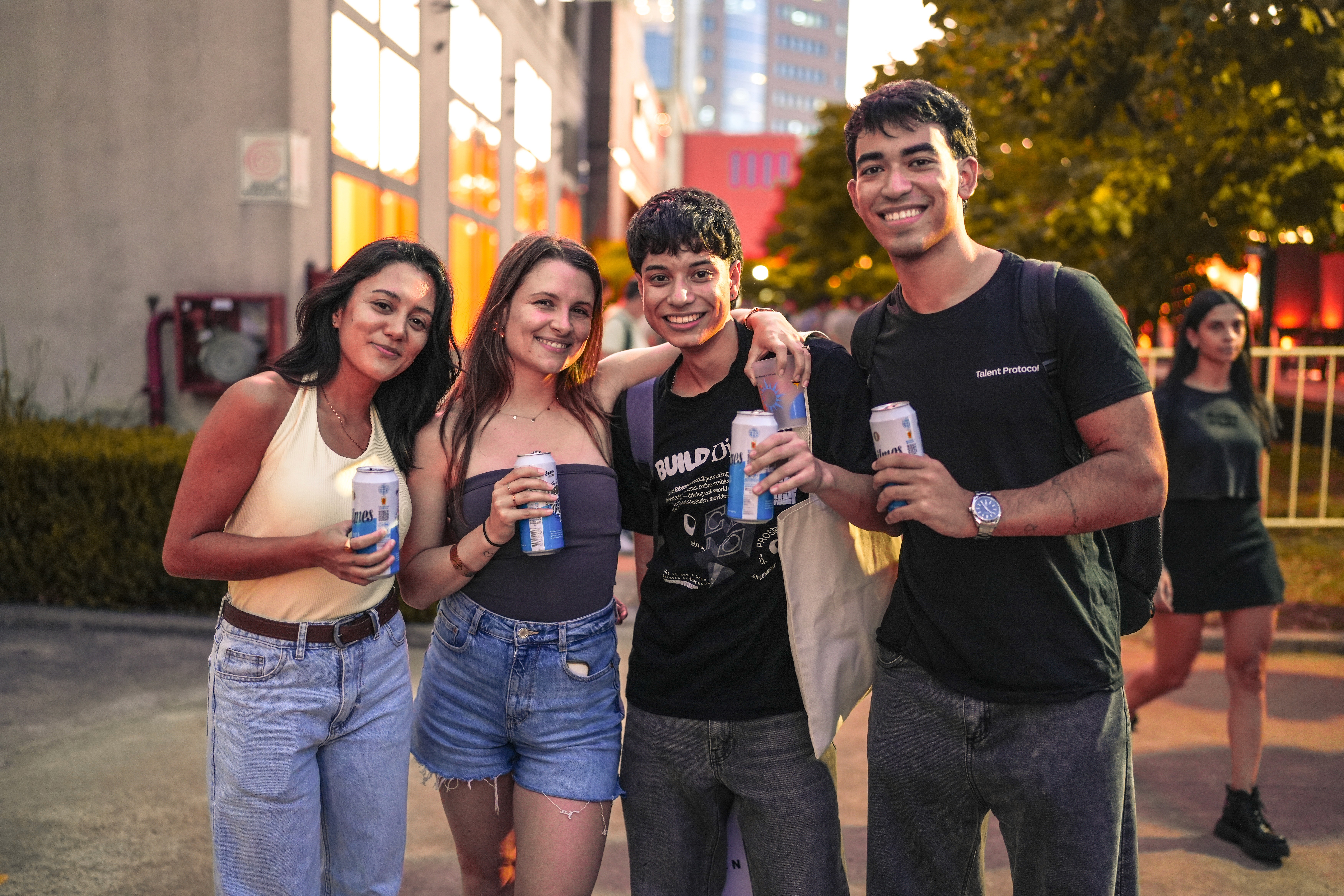 three people sitting in front of table laughing together