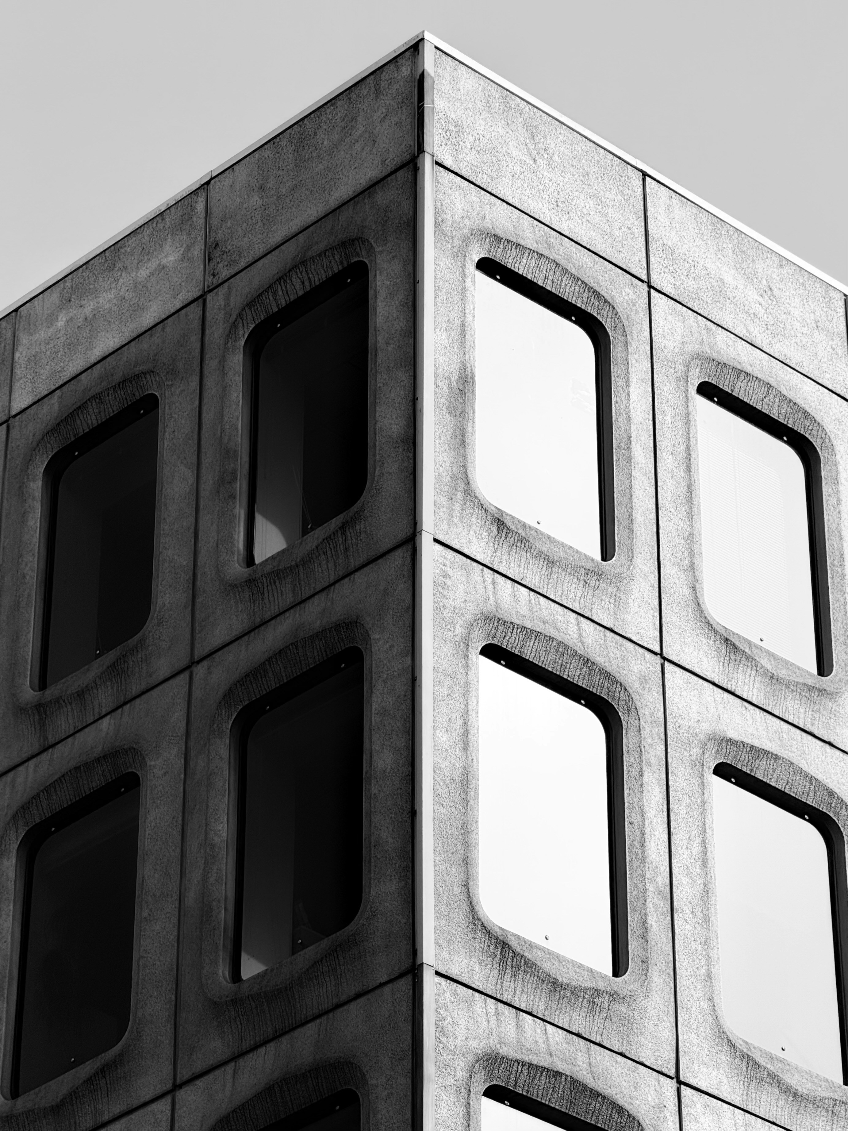 Modern concrete building corner with rounded windows