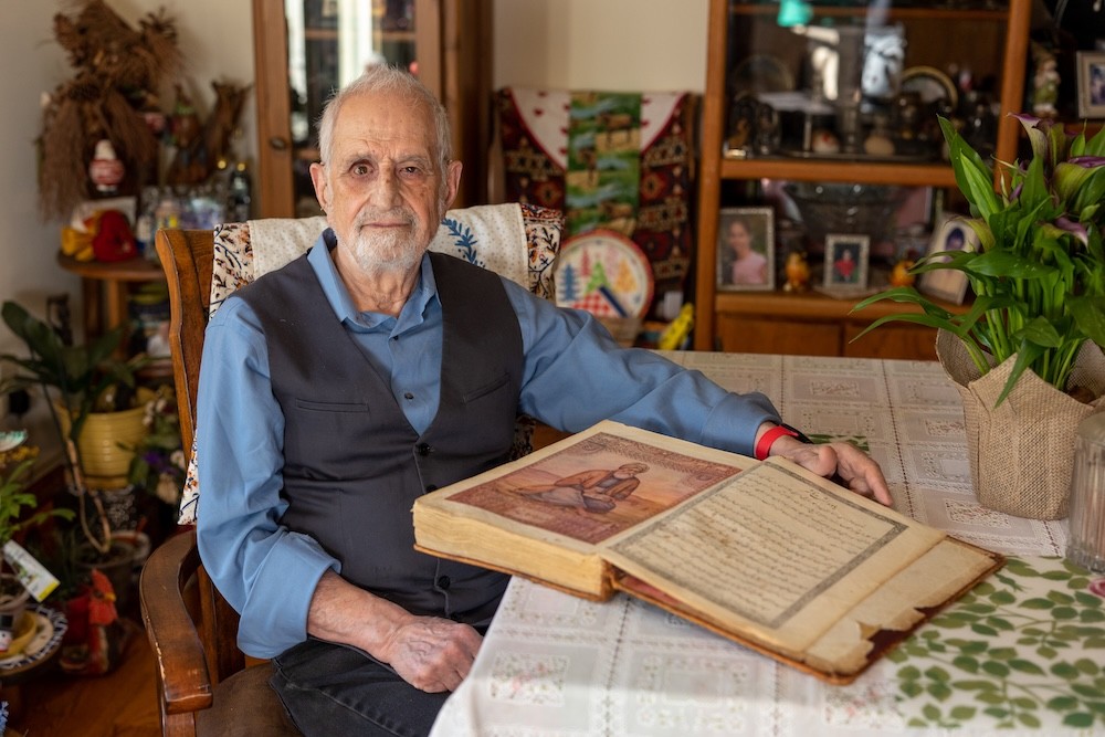 Bubjan with book and speaking to camera