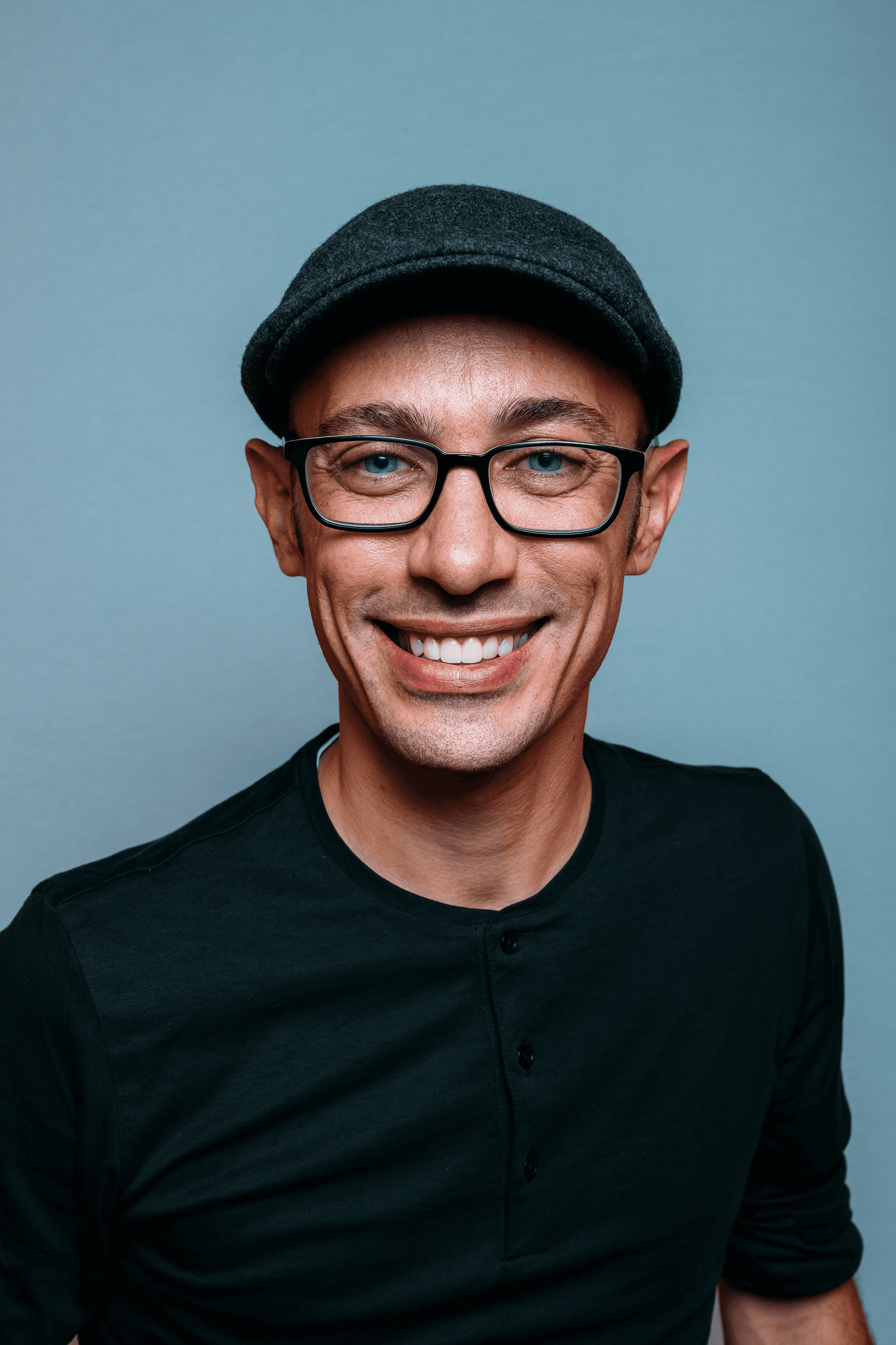 Black and white portrait of a smiling person with curly hair