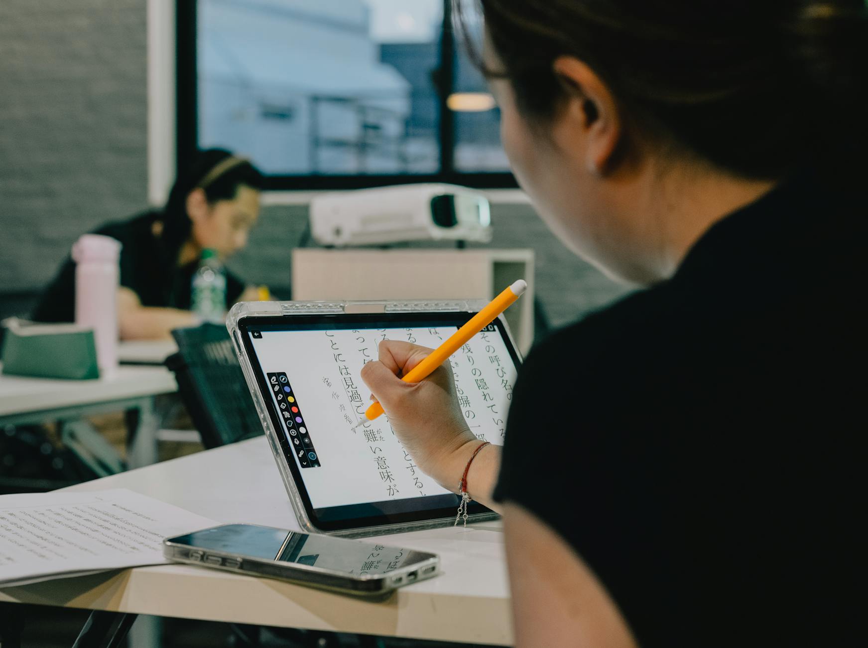 A split-screen view of a tutor and student interacting through a high-tech video conferencing software interface.
