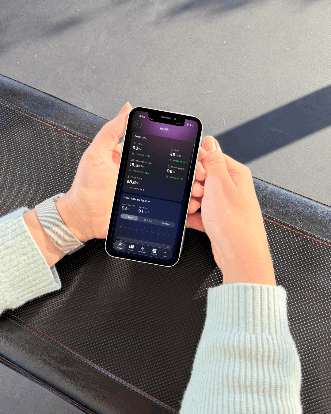 photo of a woman looking at health data on her phone in the Athlytic app