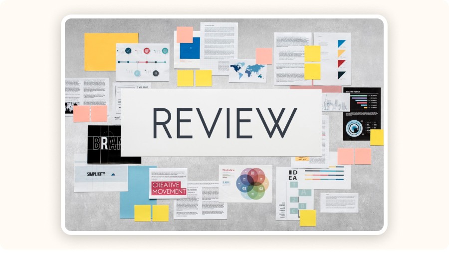 Creative review board with documents, charts, sticky notes, and branding materials