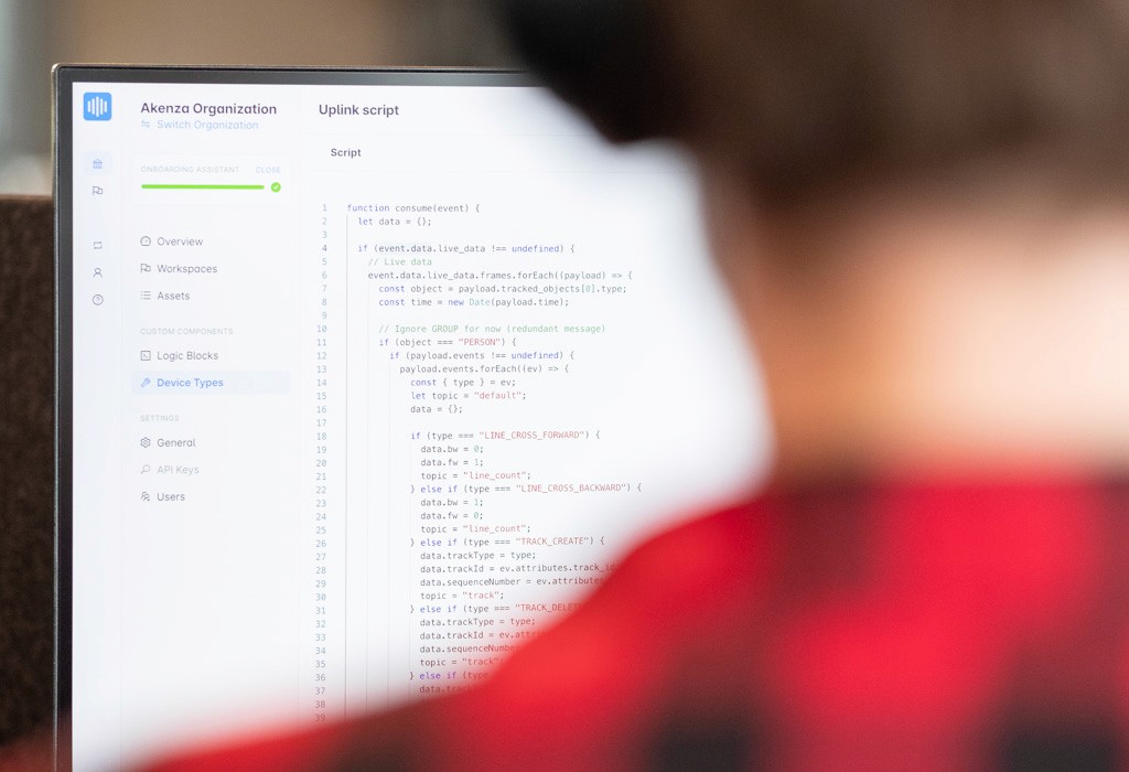 The back of a person looking onto their computer with the akenza dashboard on the screen