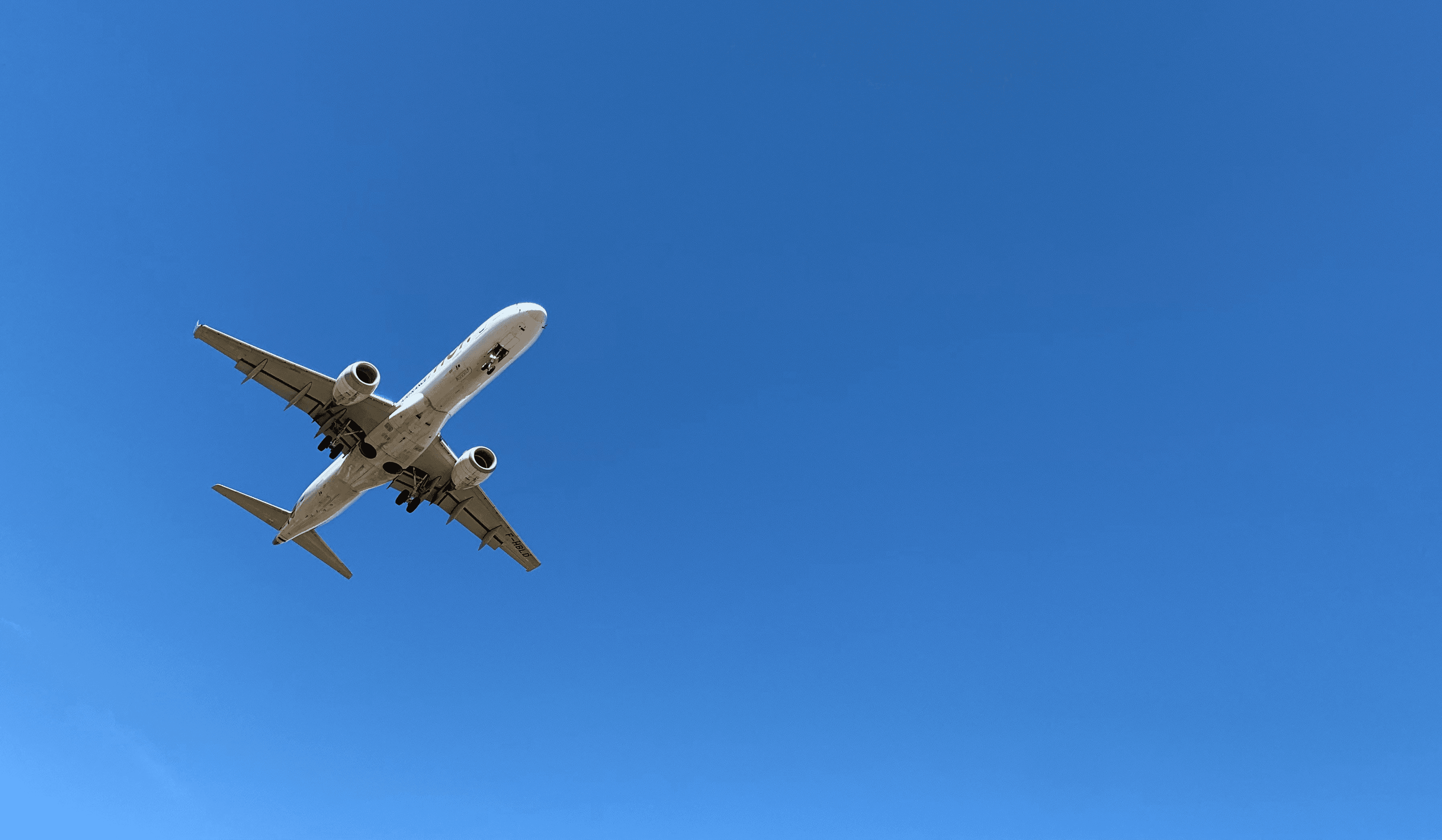 a large jetliner flying through a blue sky