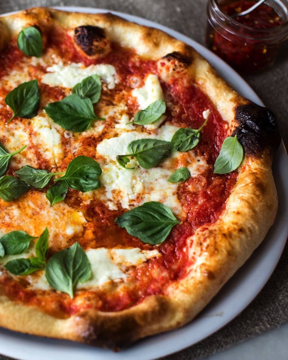 Margherita Pizza from Pasta 9 Toronto made with rich tomato sauce, mozzarella, and fresh basil for a timeless Italian classic.