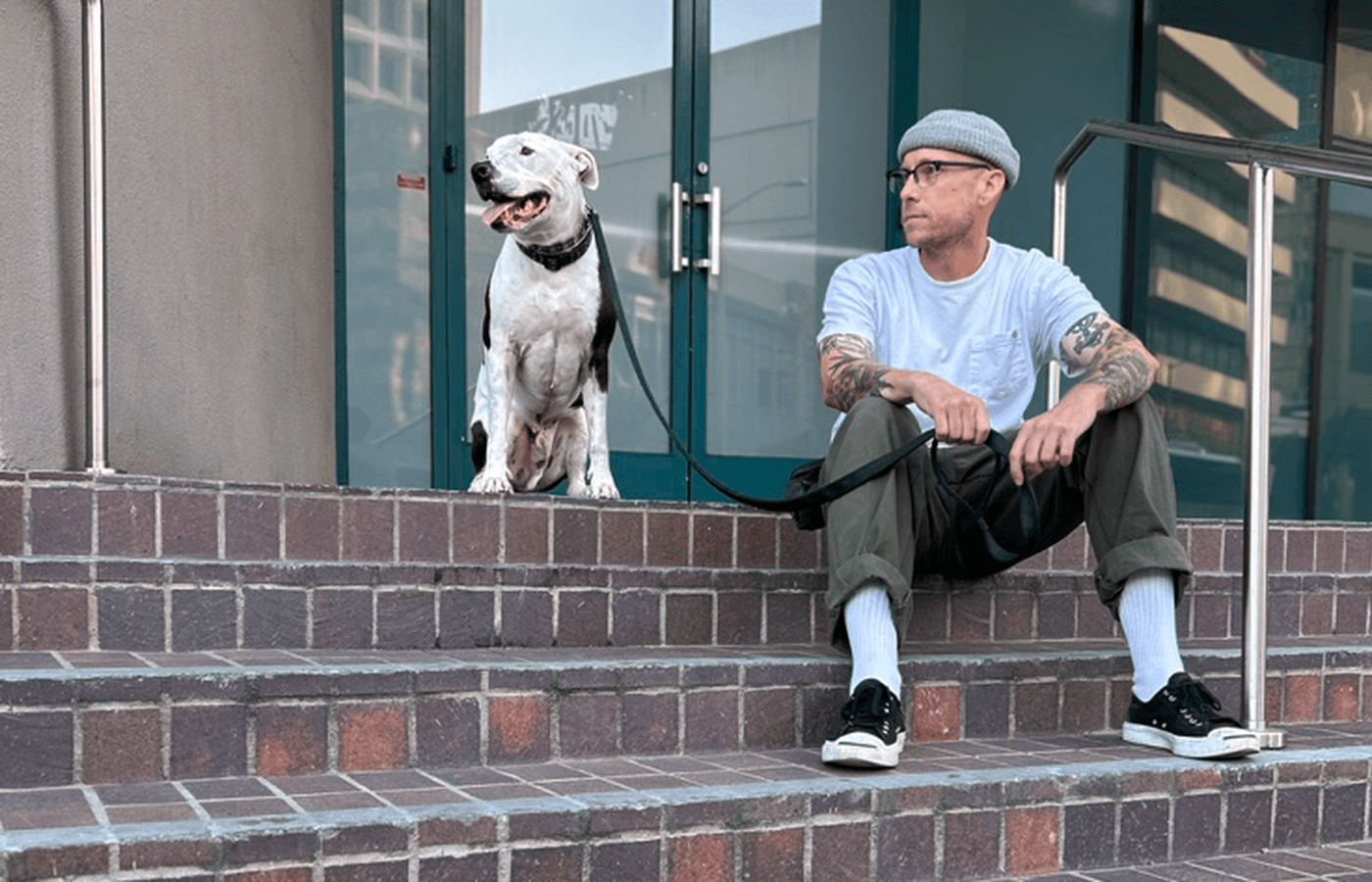 A photograph of Senior Brand Designer, Jonathan Holt with his dog, Badger, in Downtown Oakland, California.