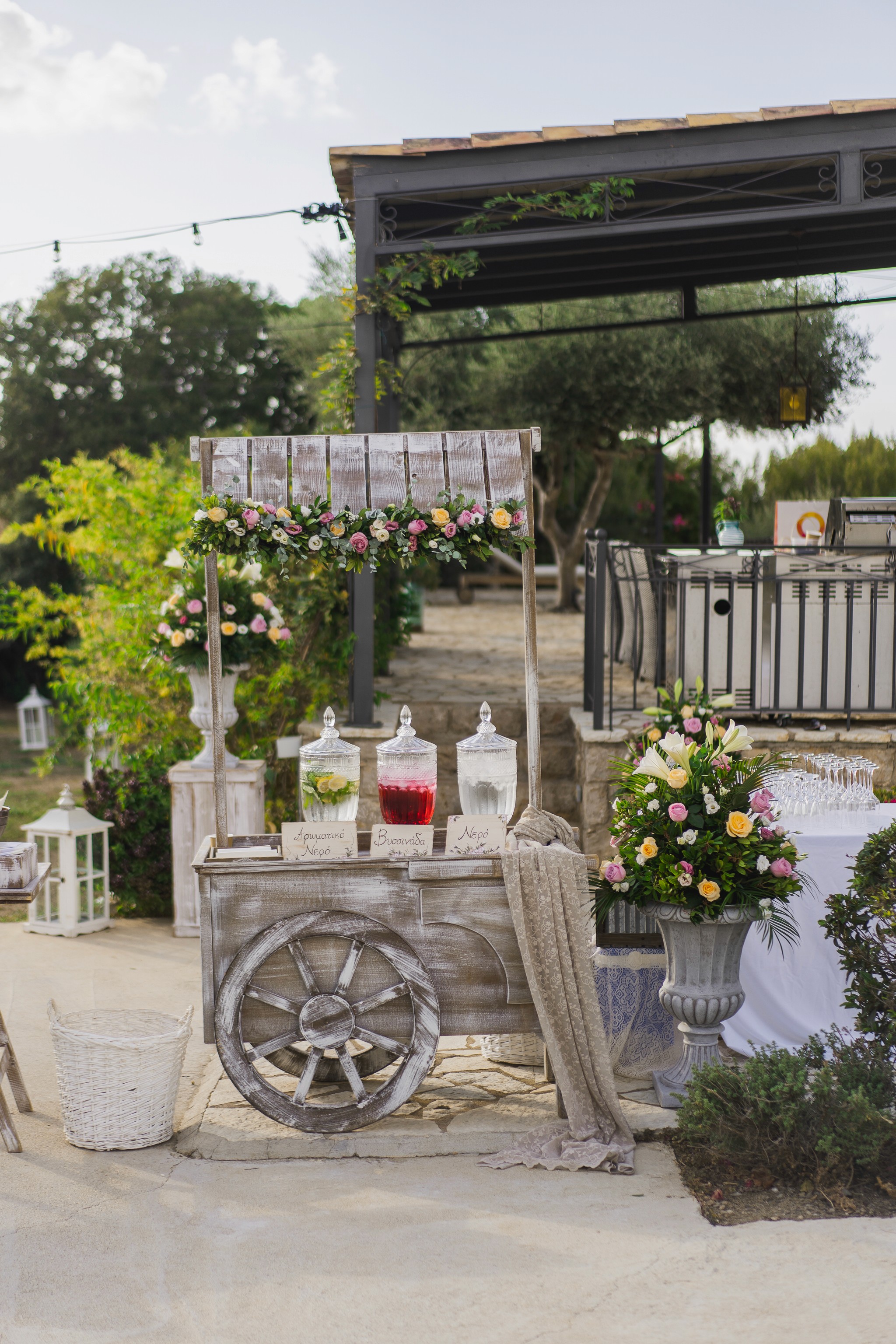 Close-up of a romantic beach wedding floral arch with white drapes by the sea in Messinia Greece