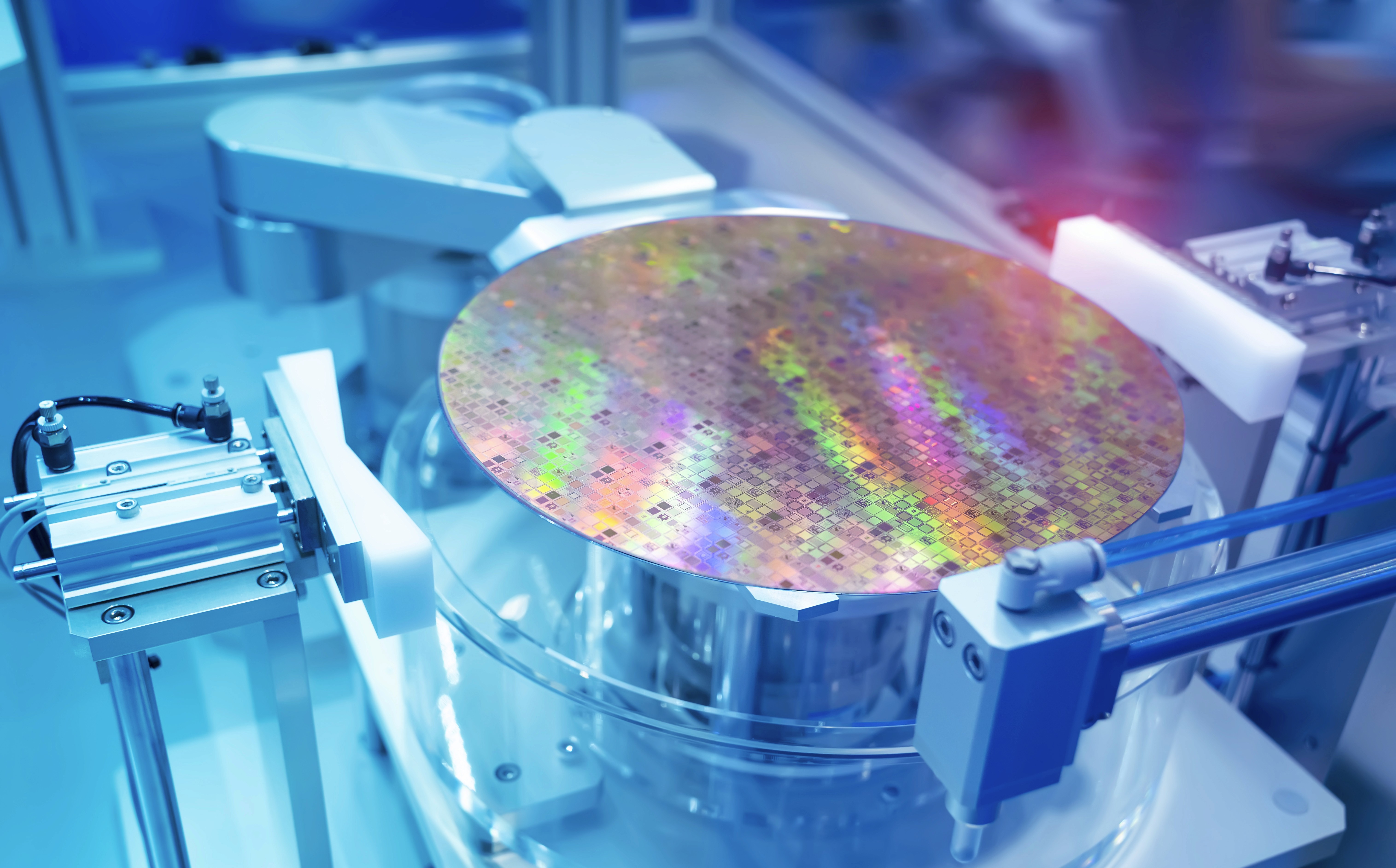 a group of people sitting around a table with laptops