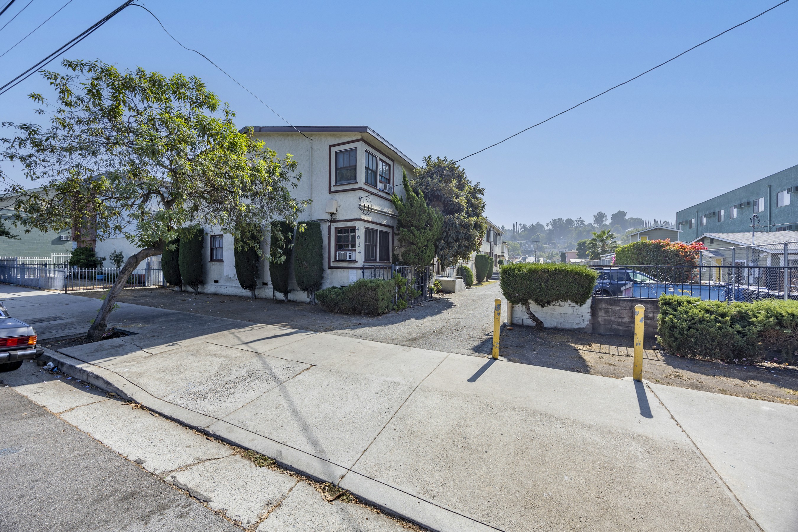 Street-level view of classic two-story apartment building frontage at 4650 york with parking area