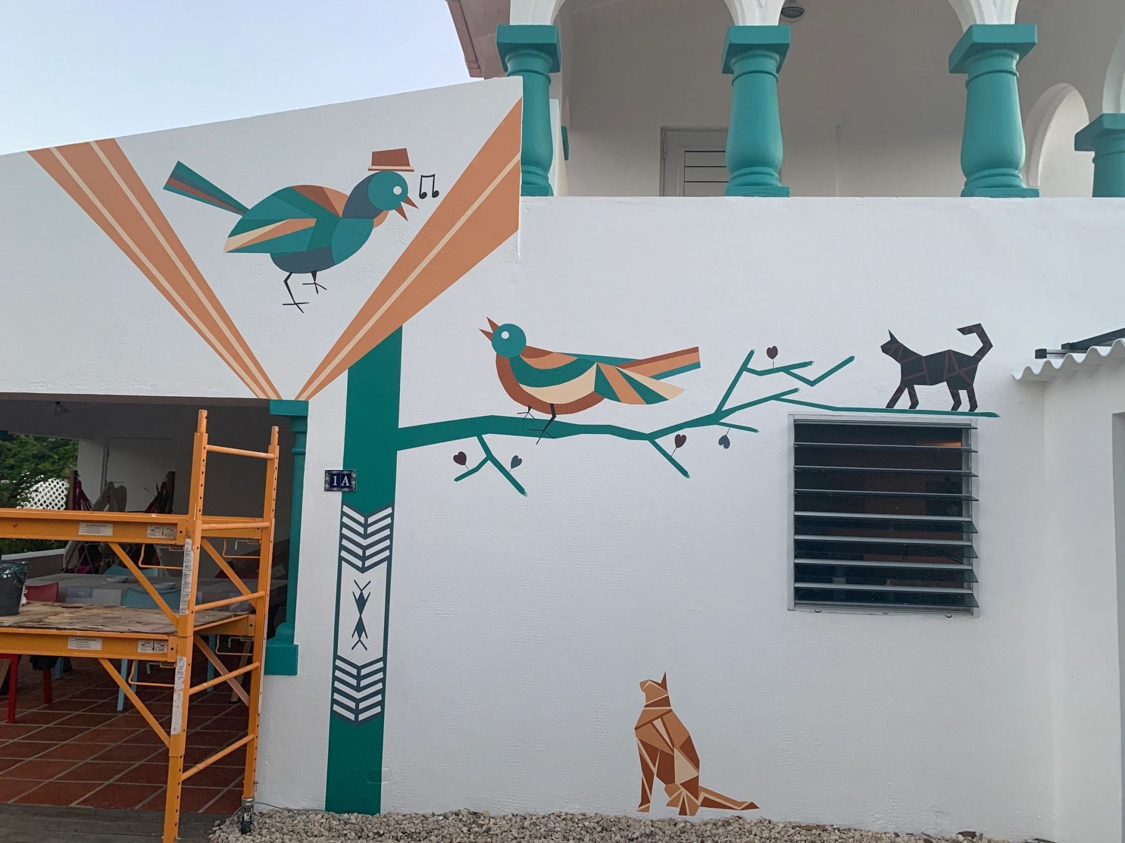 Birds and cactus mural on a house facade