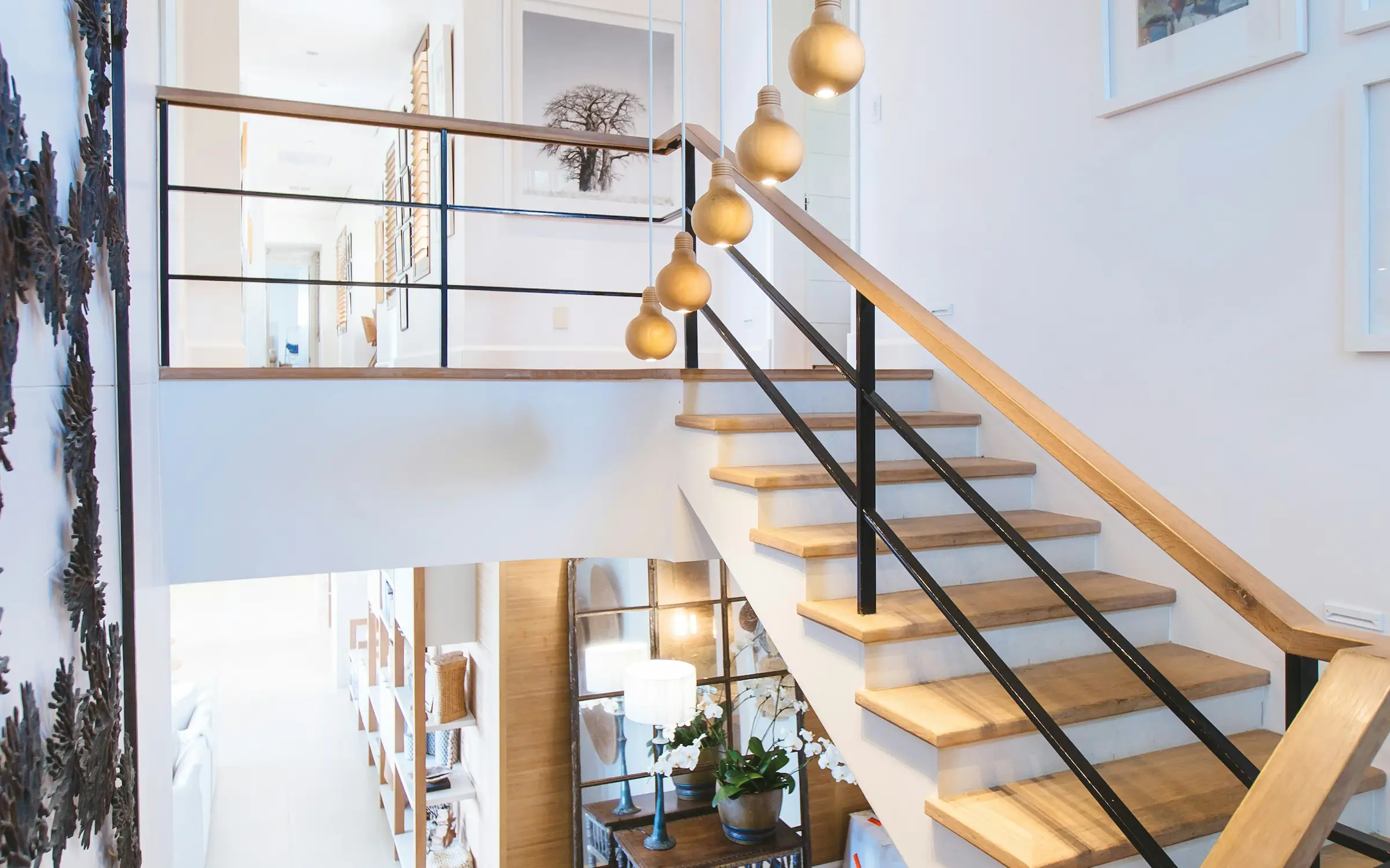 Modern interior entrance with floor-to-ceiling glass walls and warm timber cladding overlooking landscape