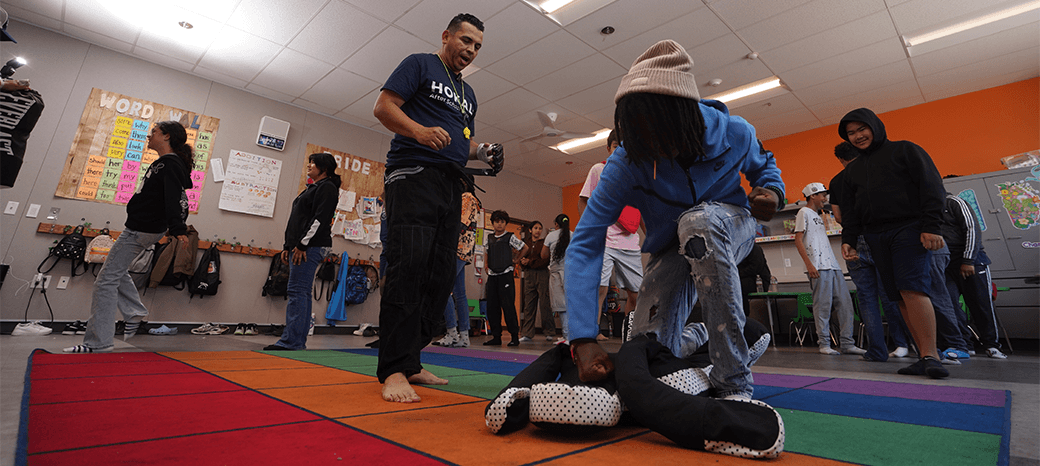 Elementary students practicing Brazilian jiu-jitsu techniques in structured after school program